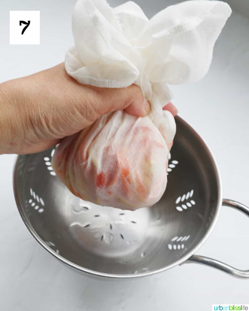 hand holding a cheesecloth with atchara in it.