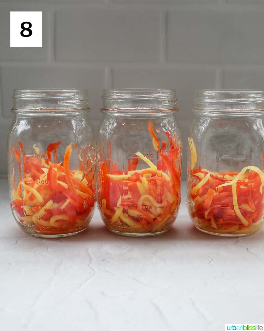 mason jars with Filipino atchara condiment - papaya, carrots, red bell pepper, garlic, ginger.