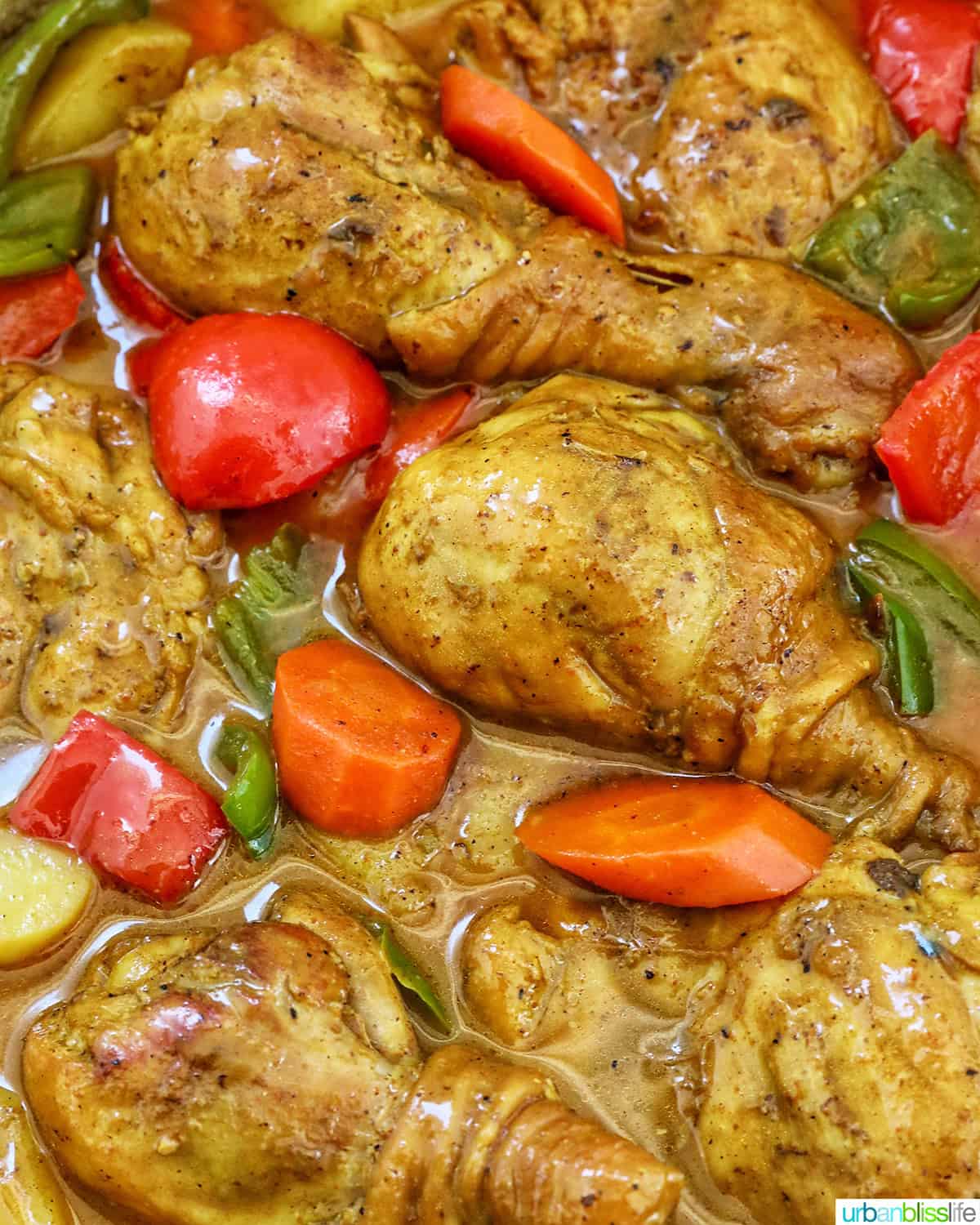 Filipino Chicken Curry with vegetables in a large pan.