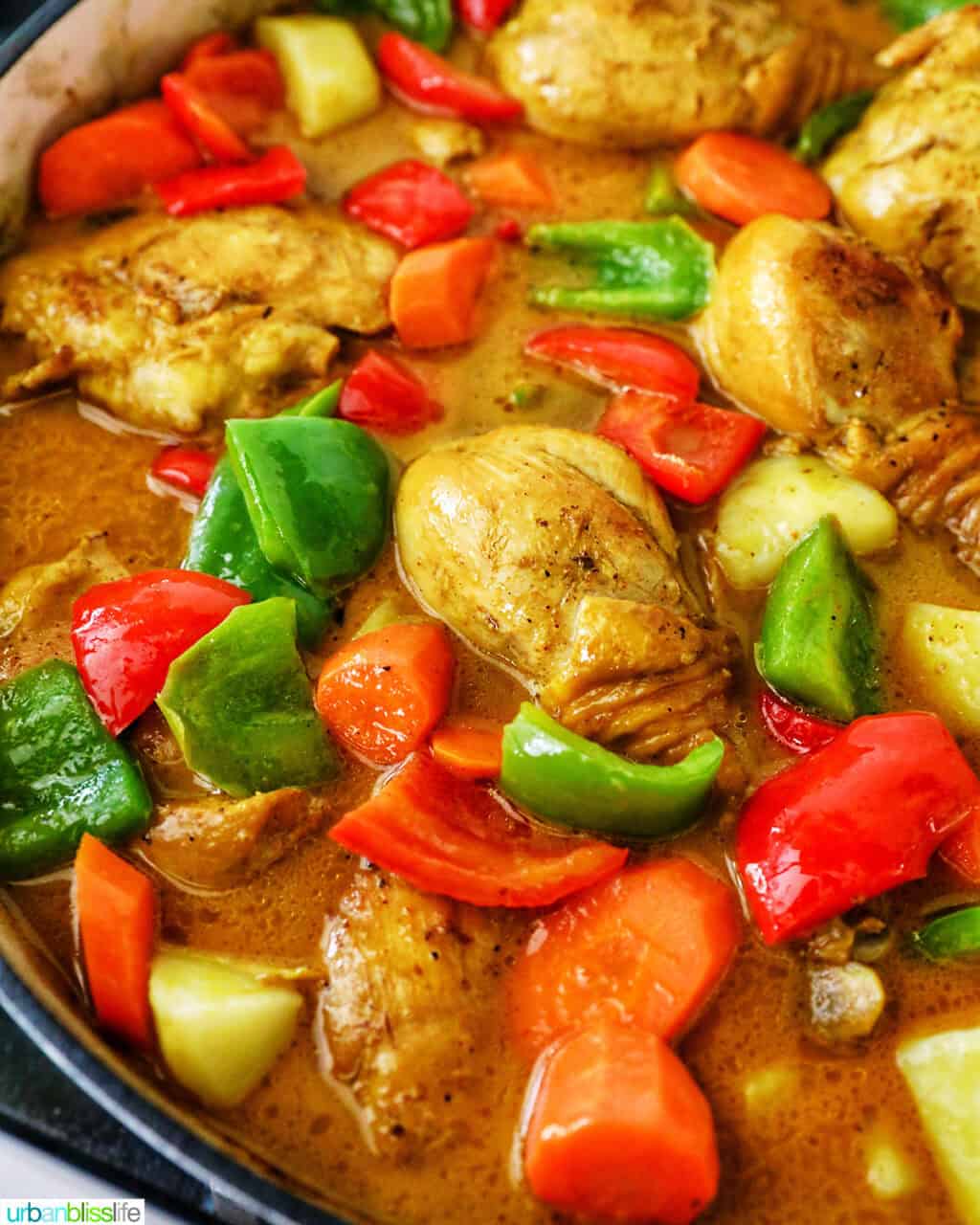 Filipino Chicken Curry with vegetables in a large pan.