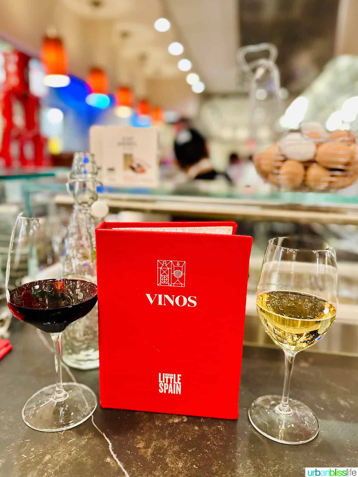 Vinos menu with two glasses of wine at Mercado Little Spain in NYC.