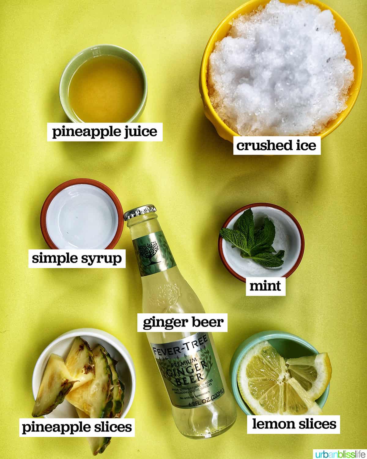 bowls of ingredients to make a pineapple mocktail drink.