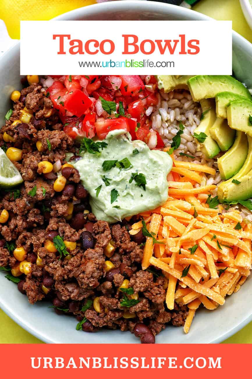 taco bowl with ground beef, beans, cheese, pico de gallo, avocado, rice, avocado cilantro lime crema with title text overlay.