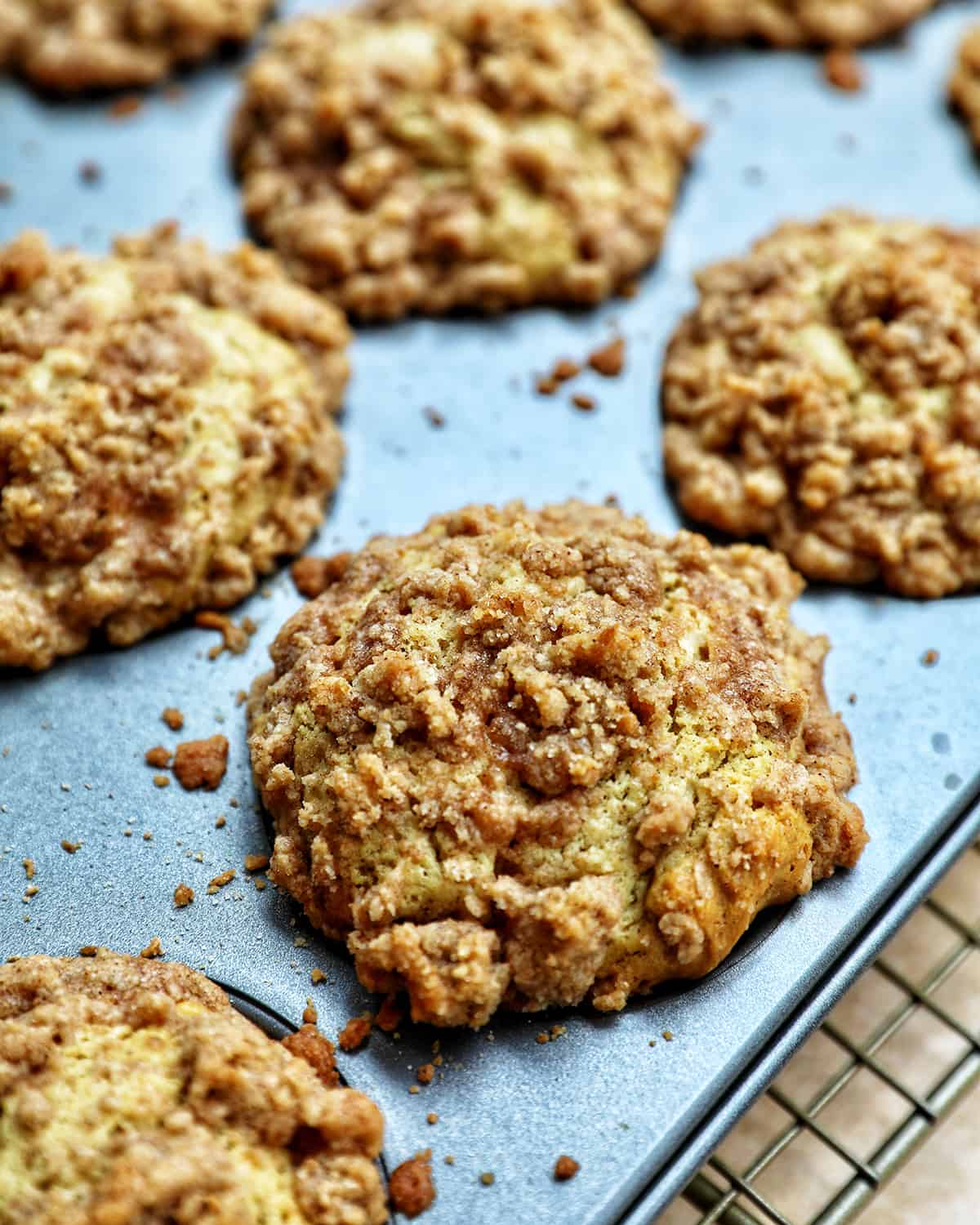 baked several vegan cinnamon streusel muffins in a muffin tin.