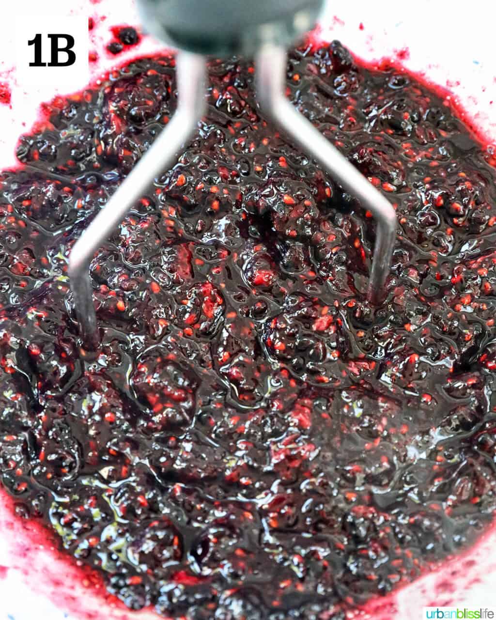 mashing blackberries to make jam.