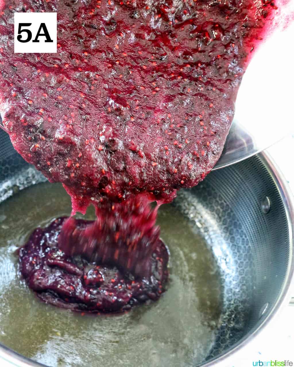 adding blackberry mixture to fruit pectin in a saucepan.