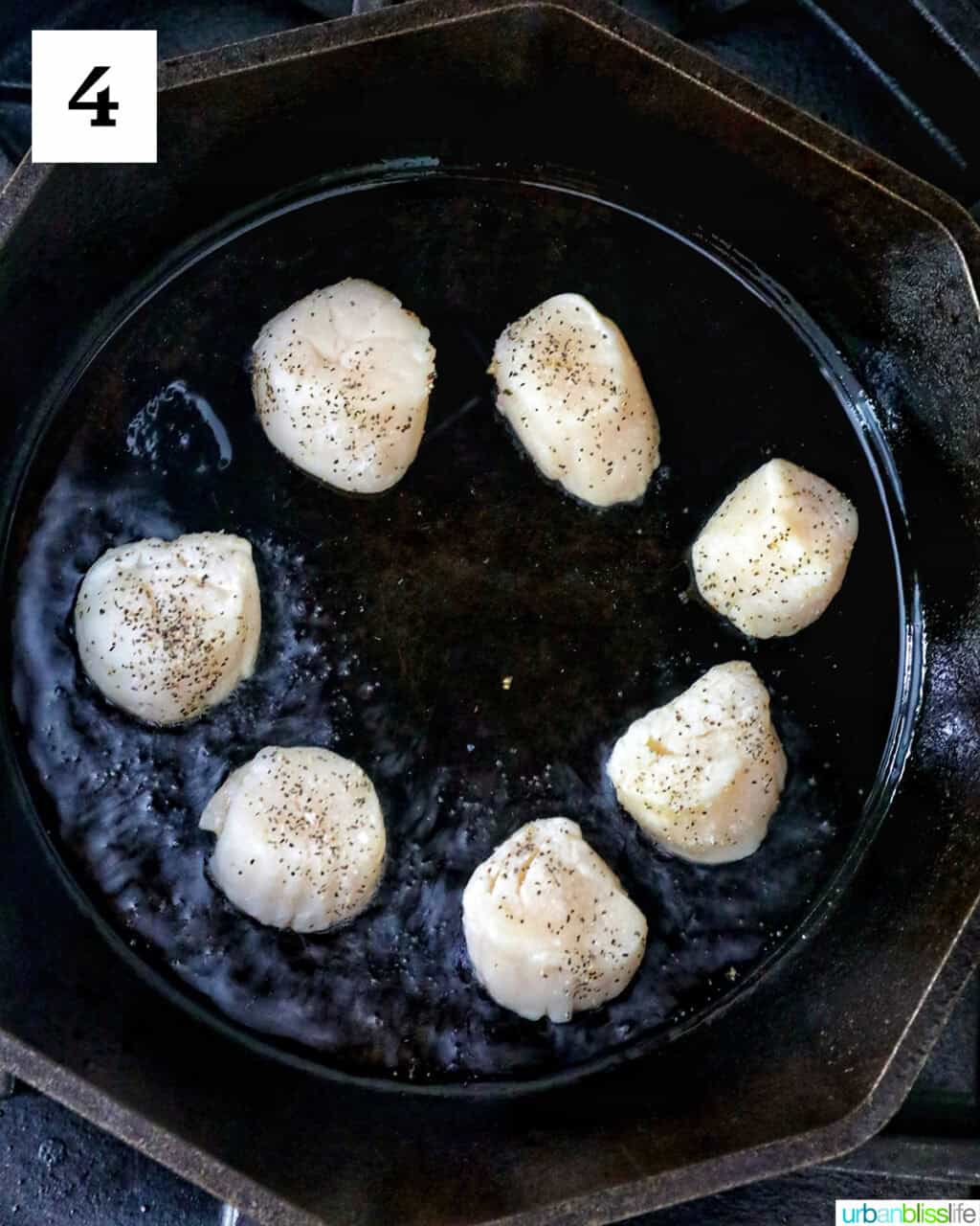 several scallops in a cast iron skillet.