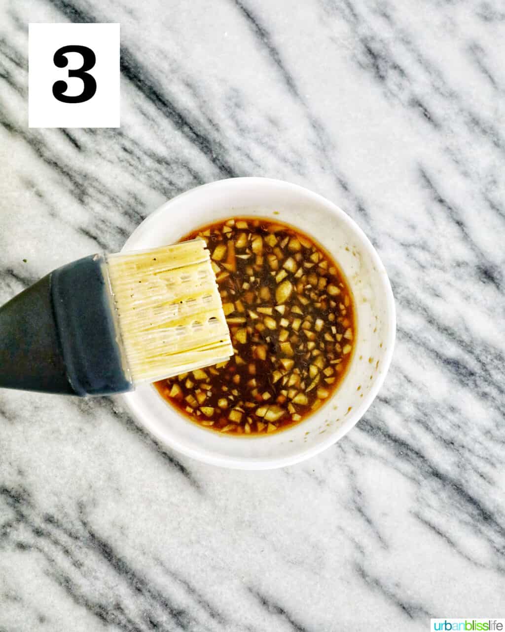 basting brush with hawaiin BBQ sauce in a bowl.