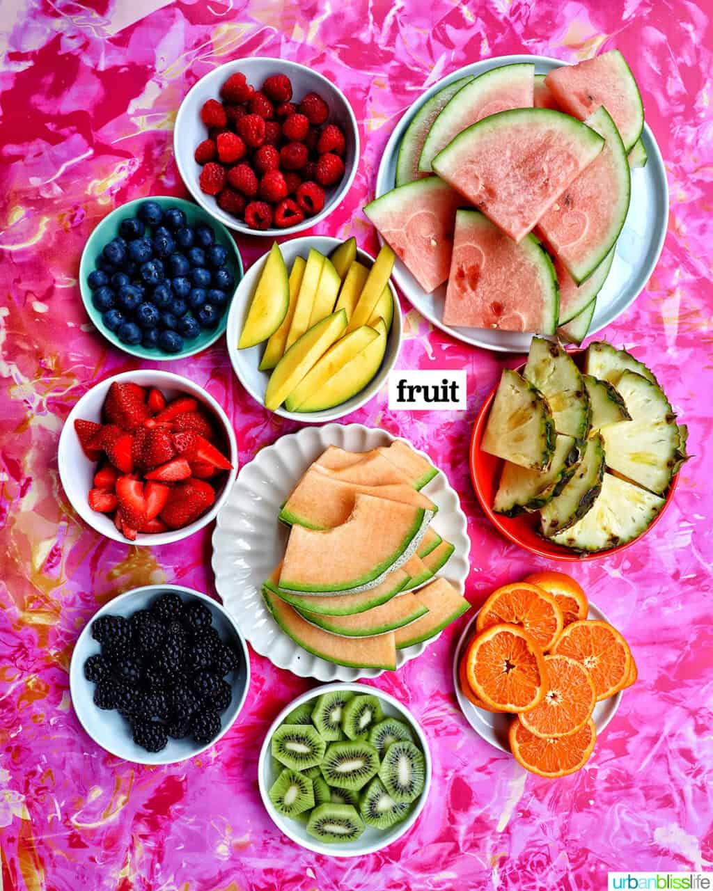 bowls of ingredients to make a summer charcuterie board.