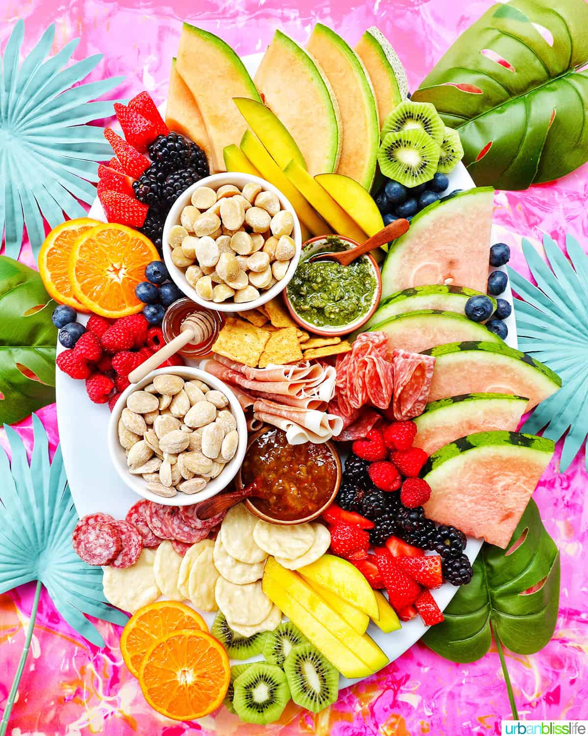 meats, cheeses, crackers, summer fruits and vegetables, nuts, and dips to create a summer charcuterie board.