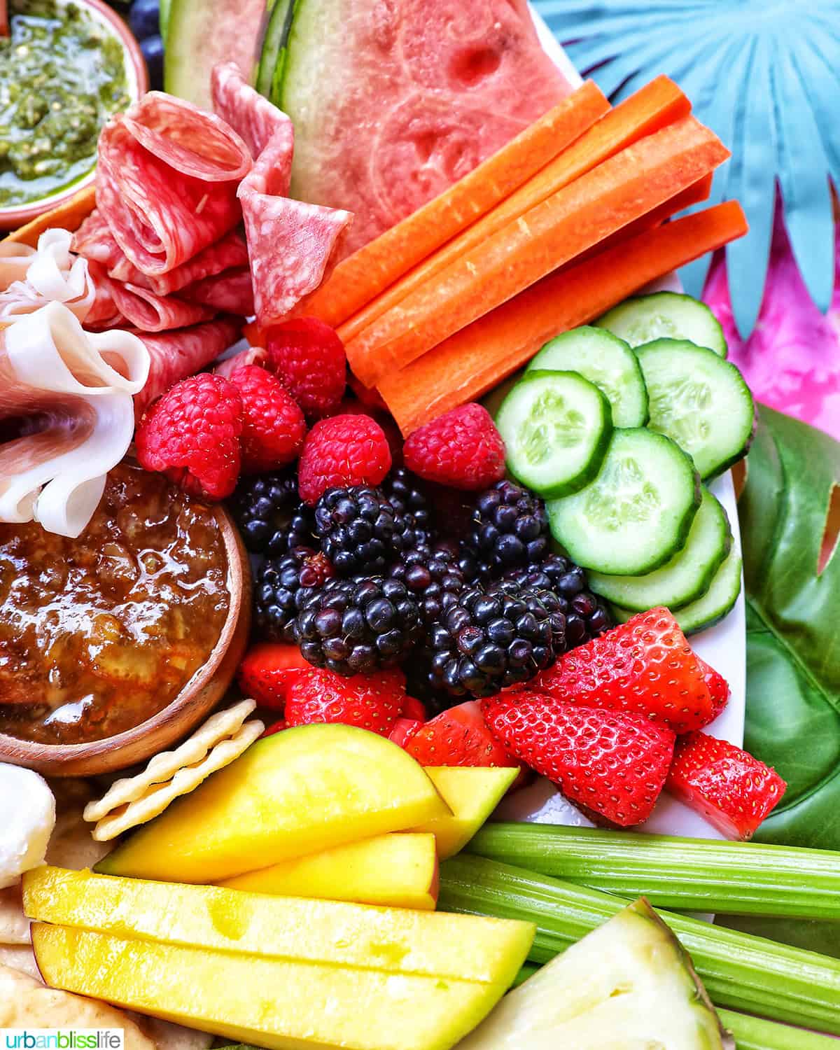 meats, cheeses, crackers, summer fruits and vegetables, nuts, and dips to create a summer charcuterie board.