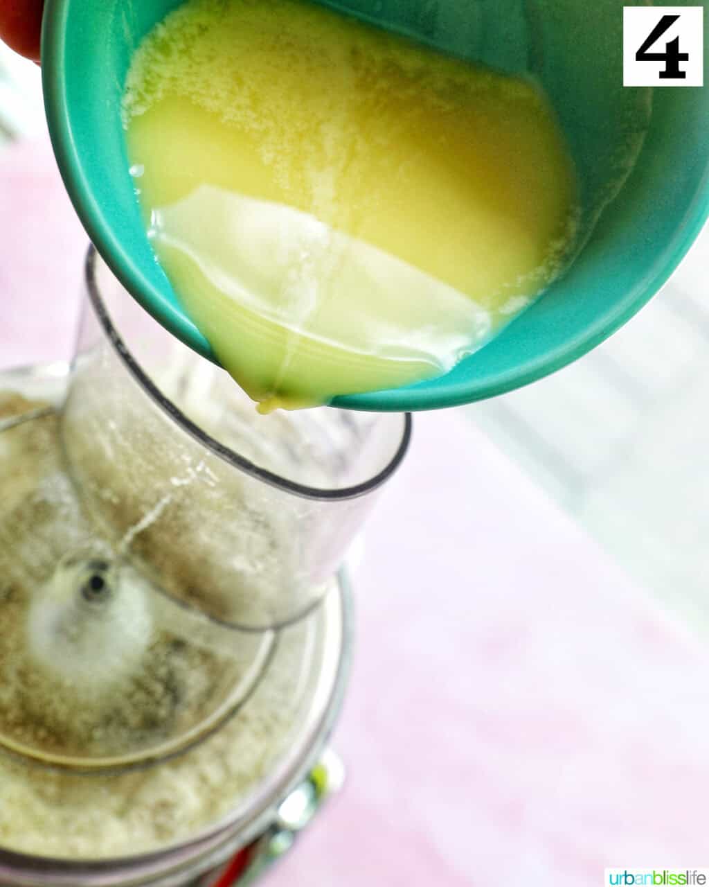 pouring melted butter into a food processor to make homemade pie dough.