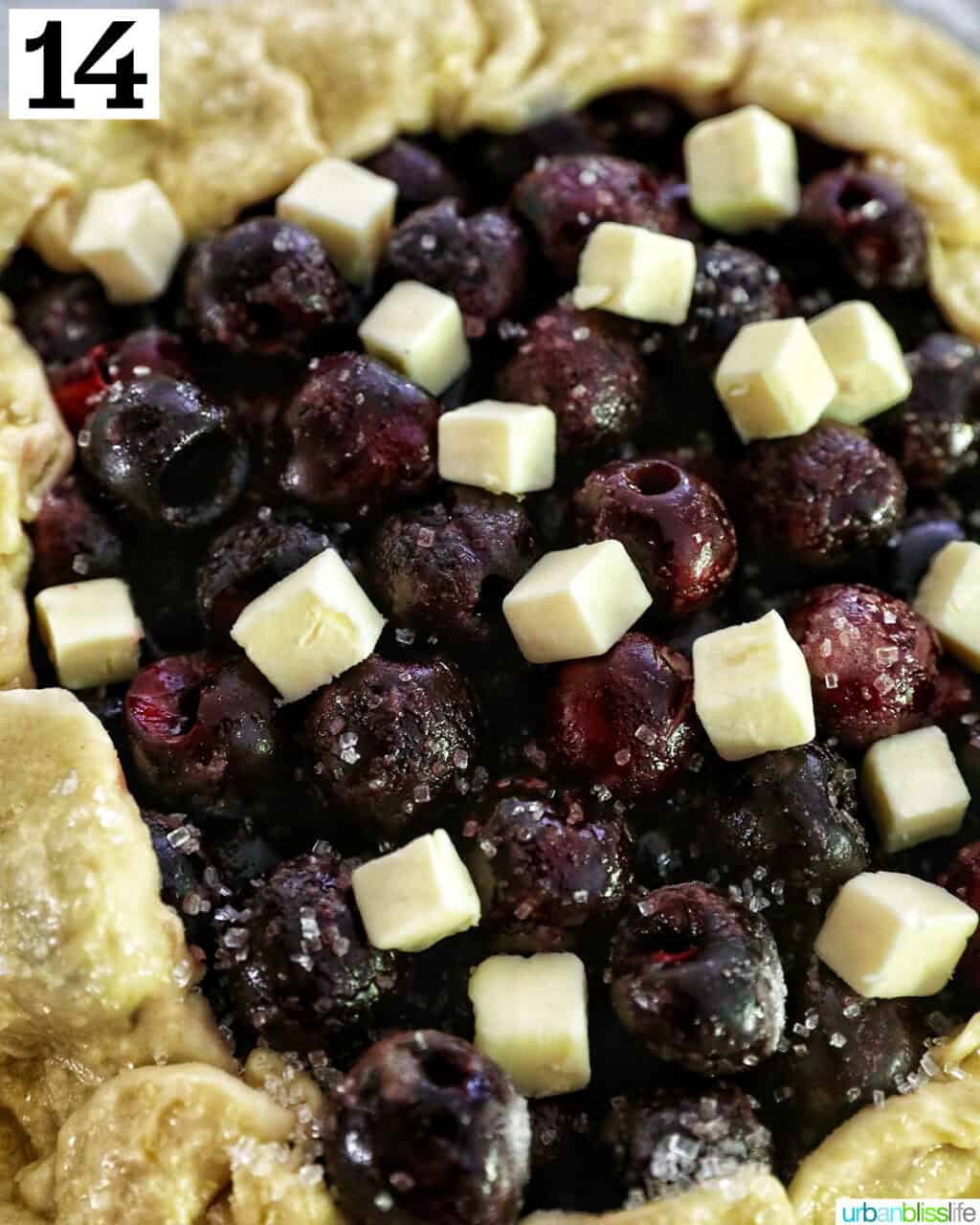 butter cubes sitting on top of cherry filling in an unbaked cherry galette.