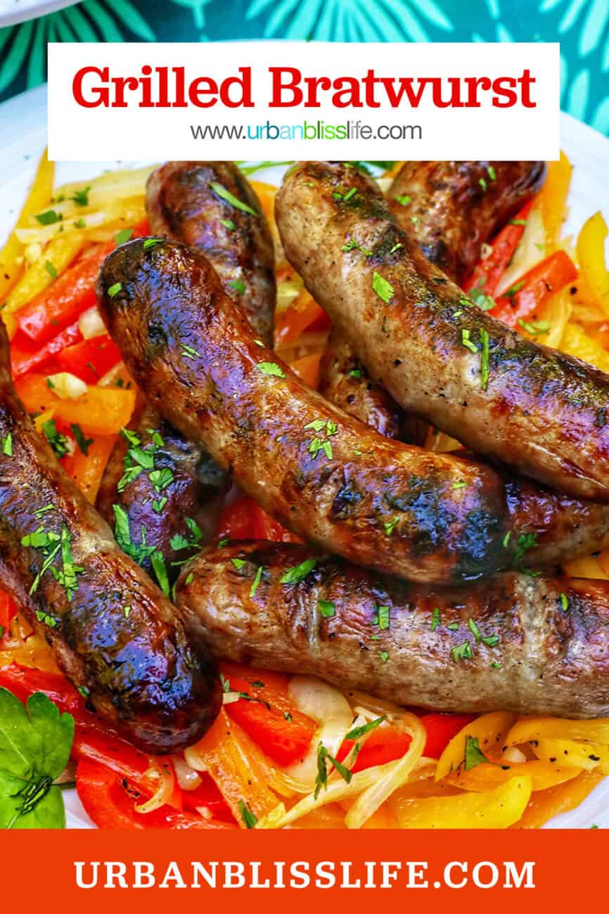 plate of grilled bratwurst over sauteed peppers with title text overlay.