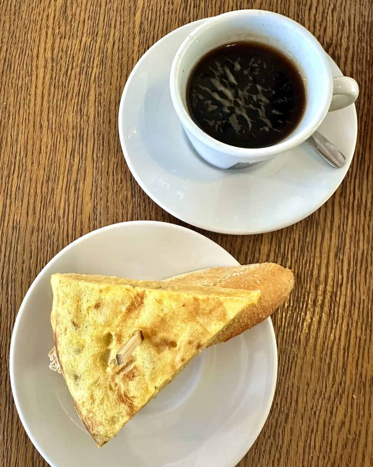 pintxos of tortilla de patatas and cup of coffee.