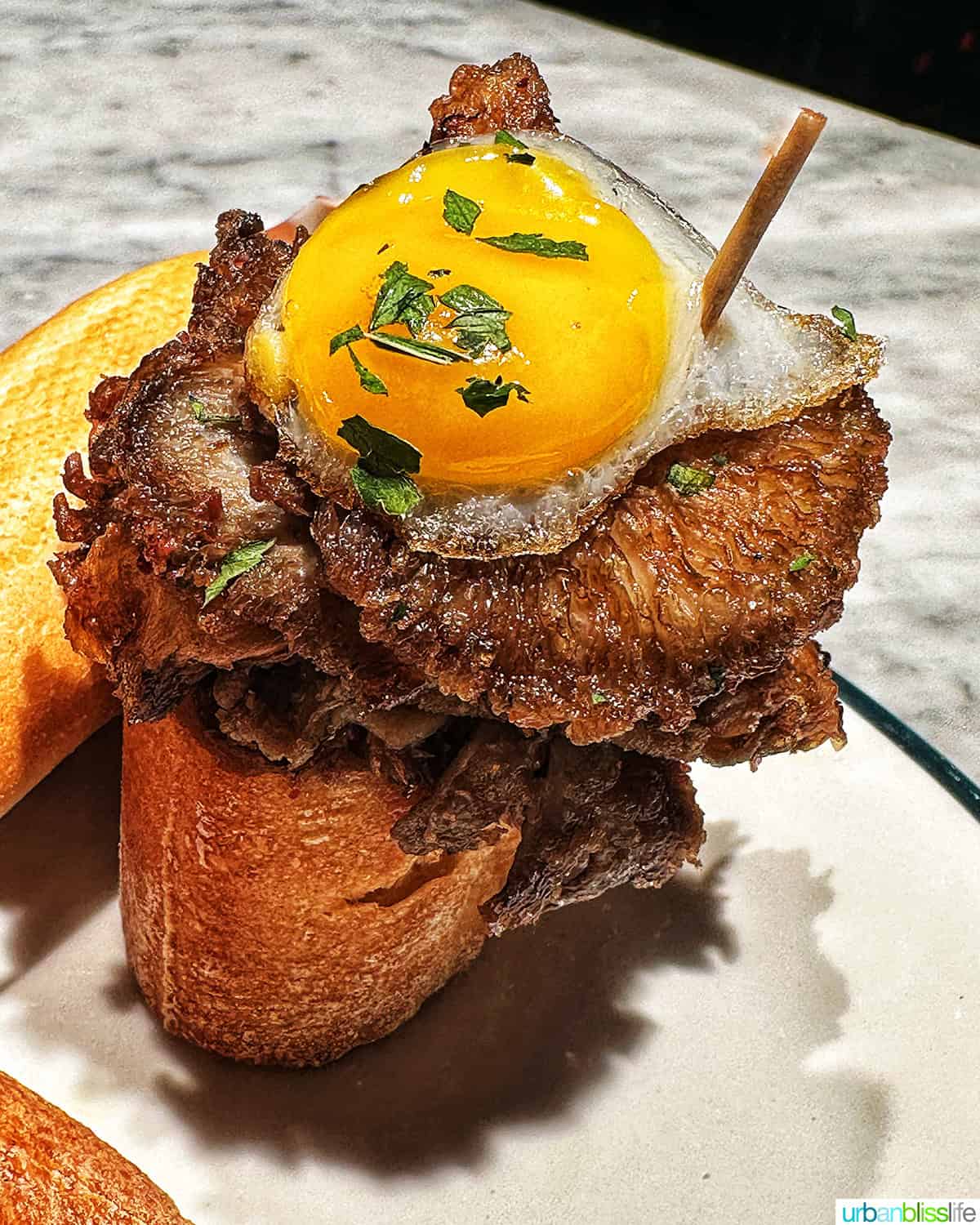 egg on top of steak on bread pintxos.