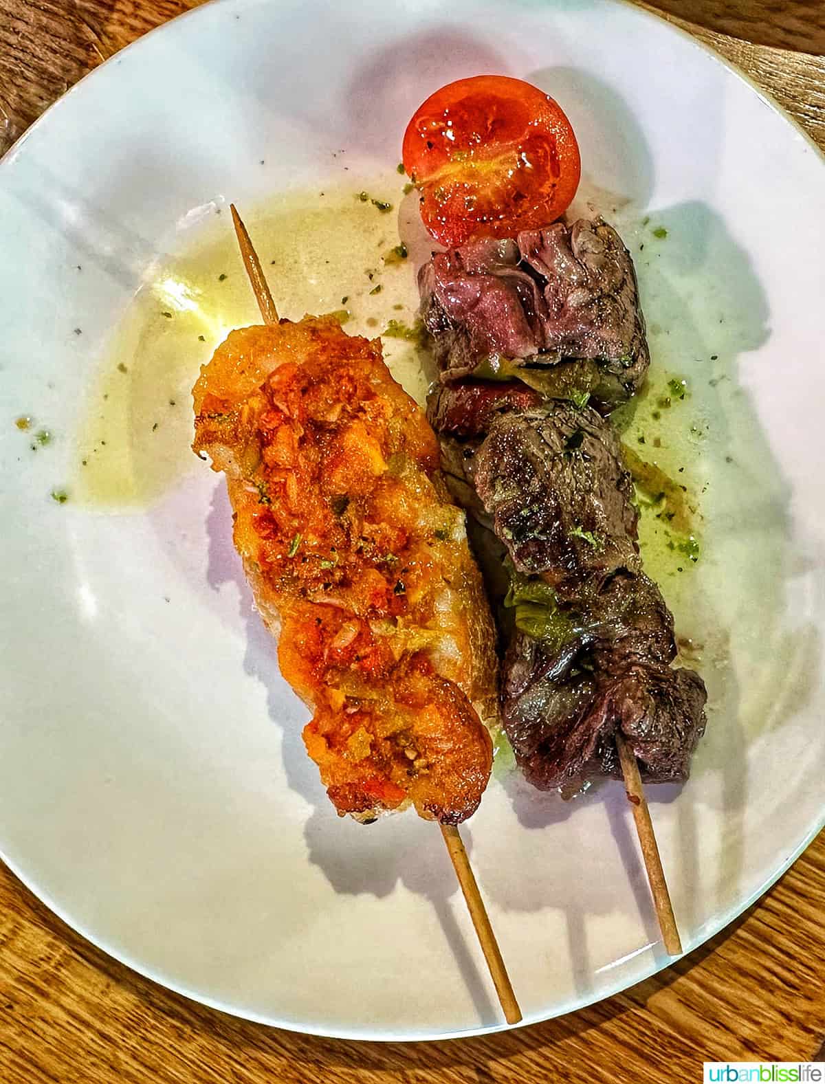 plate with two different pintxos - steal and shrimp.