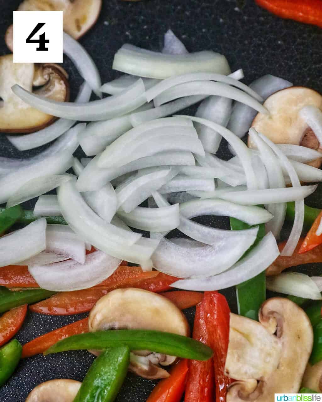 sautéed peppers and onions cooking in a skillet.
