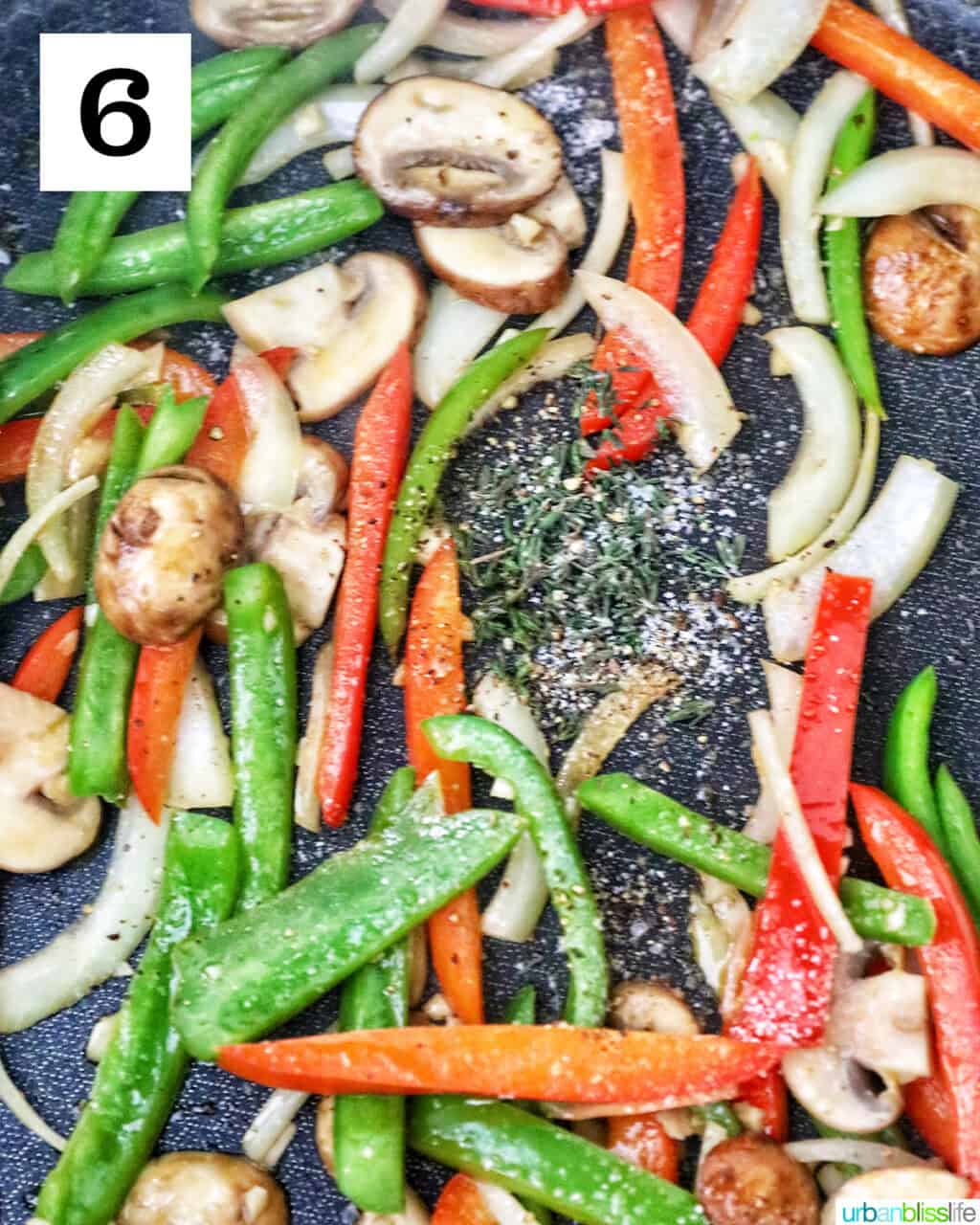 sautéed peppers and onions cooking in a skillet.