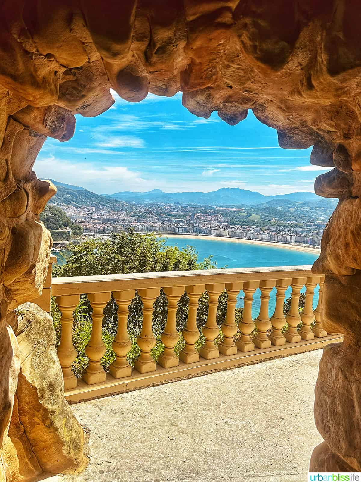 view overlooking San Sebastian, Spain from a stone archway