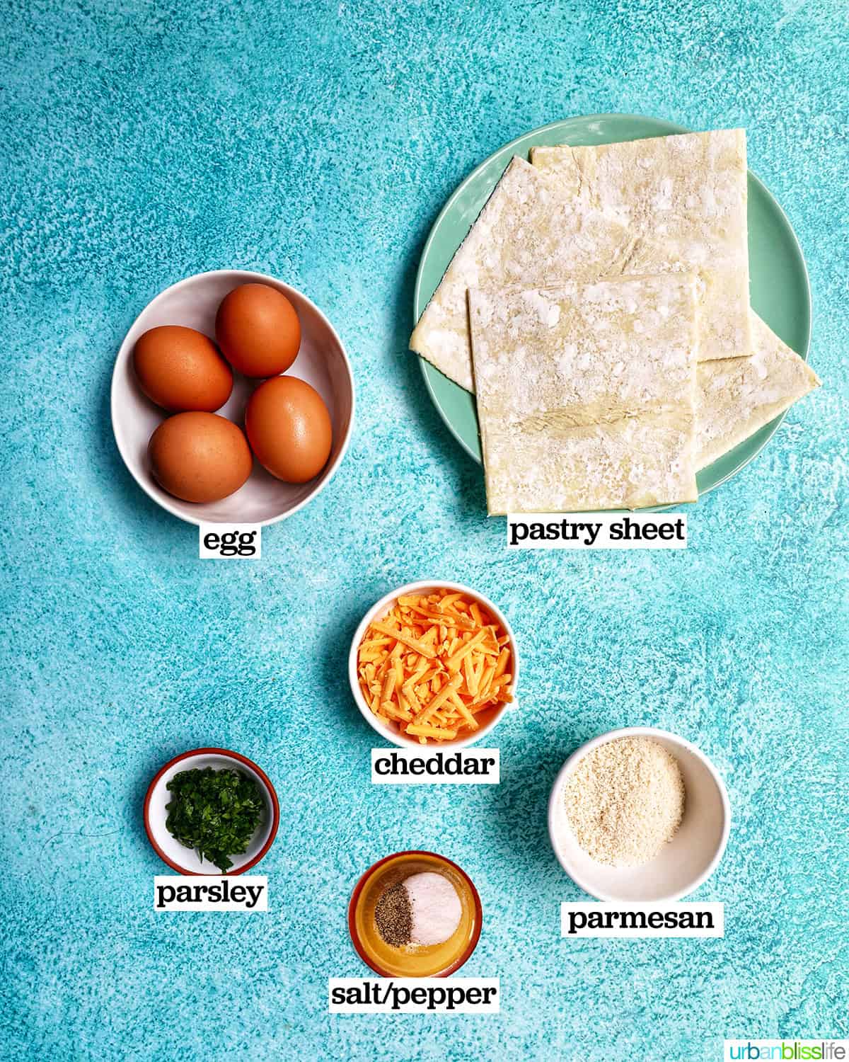 bowls and plates of ingredients to make eggs in puff pastry.
