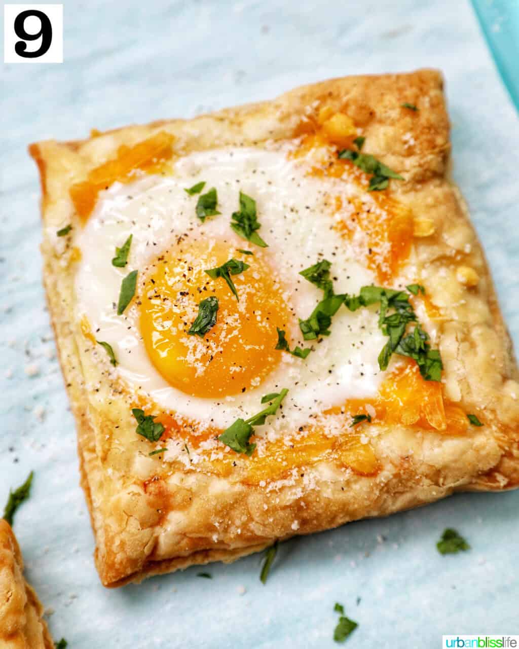 eggs in puff pastry baked on a parchment paper-lined baking sheet.