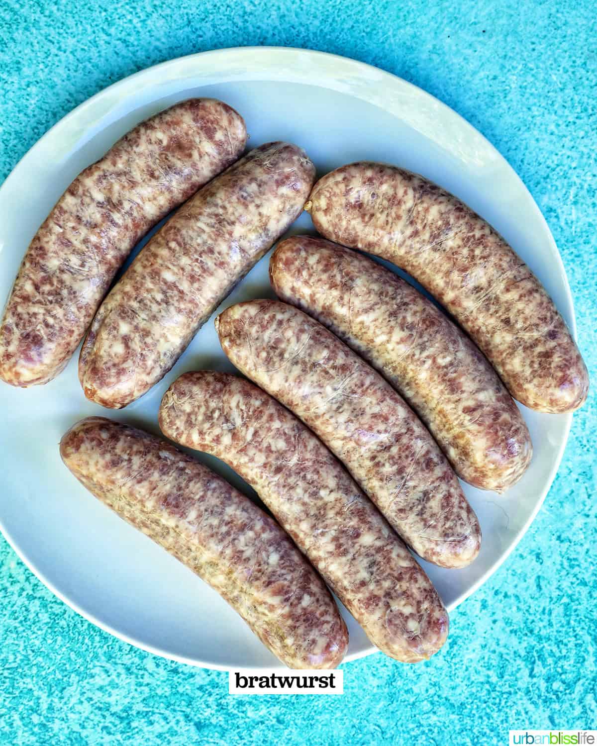 uncooked bratwurst on a plate.