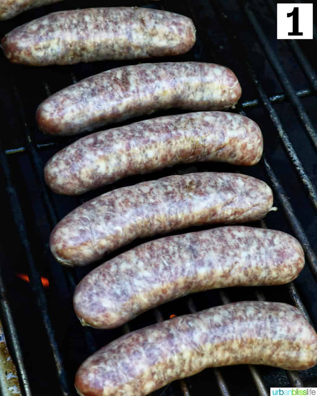 uncooked brats on a grill
