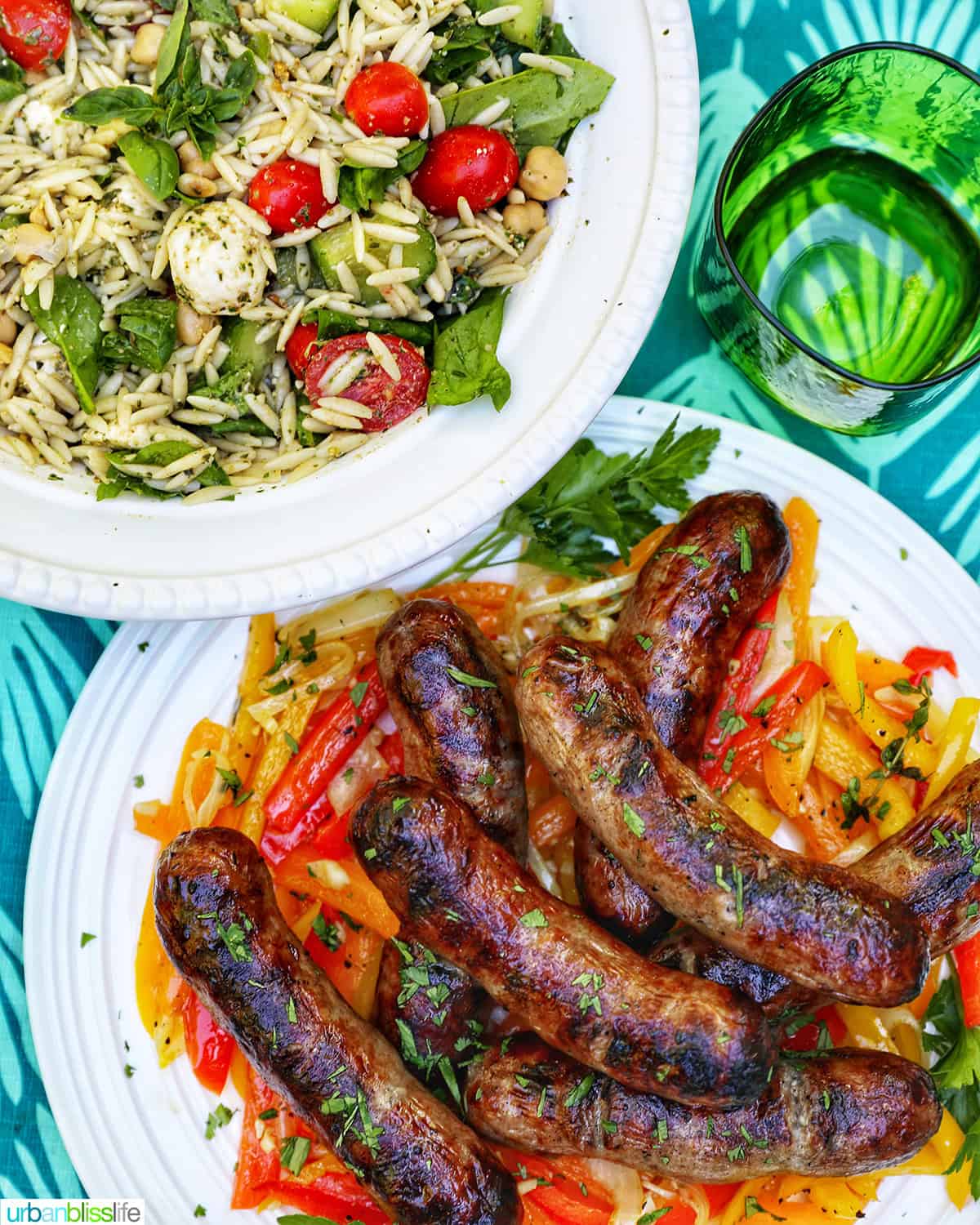 bowl of orzo pesto salad, bowl of grilled bratwurst