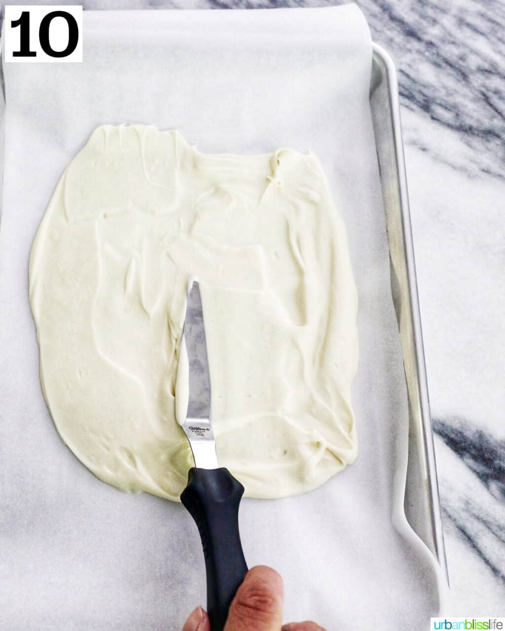 icing spatula over white chocolate.