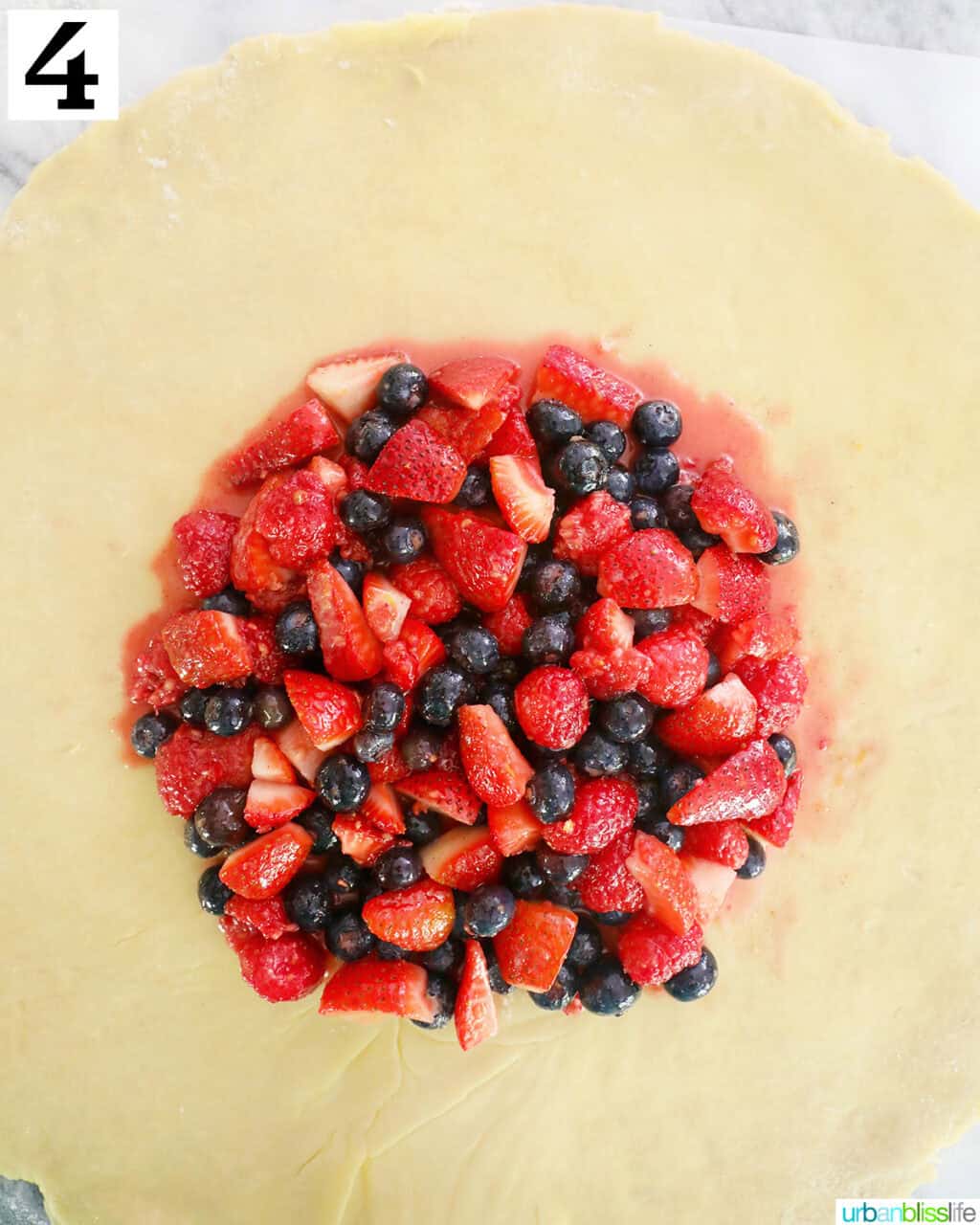 mixed berries on top of the center of pie dough.
