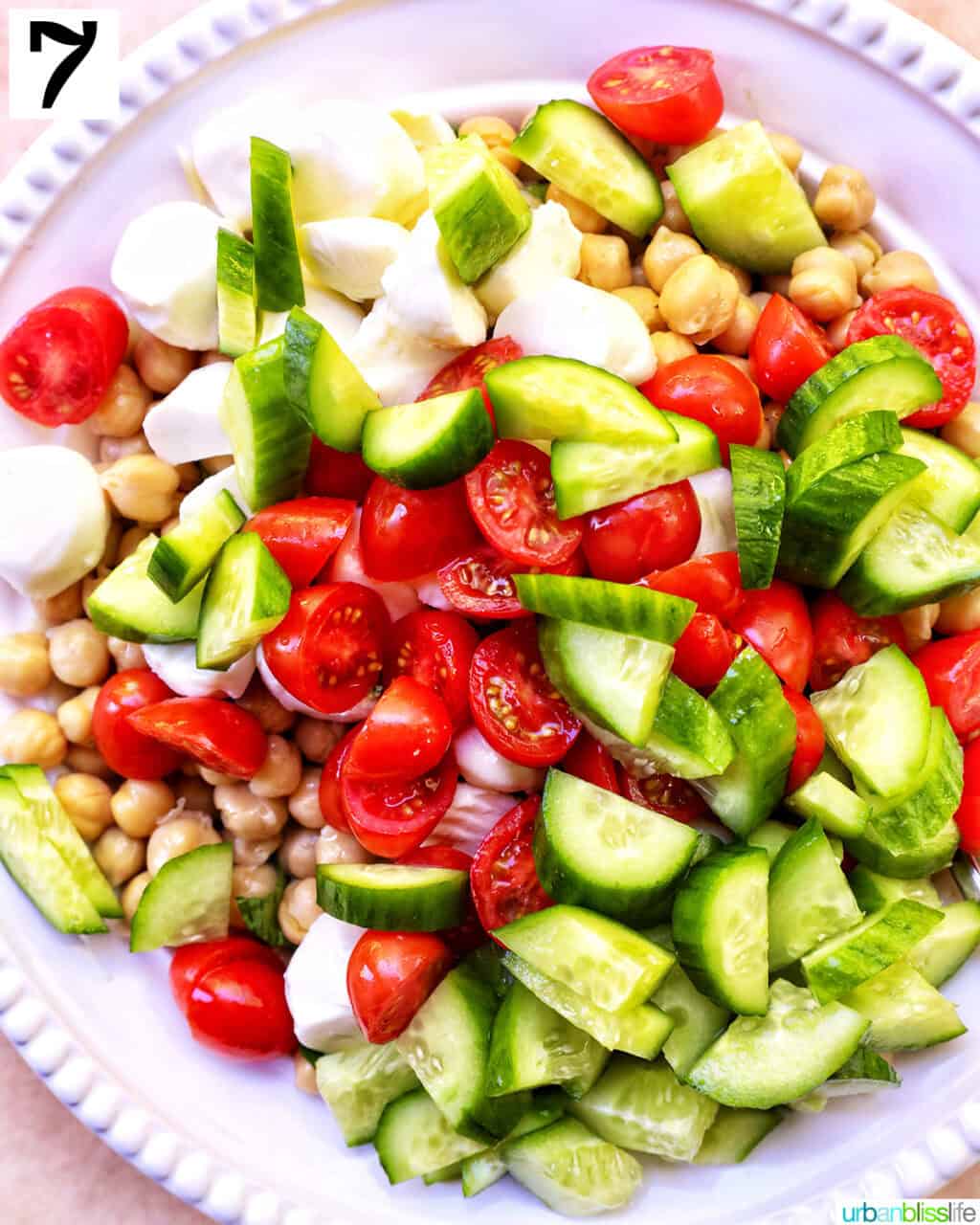 tomatoes, cucumbers, chickpeas in a bowl.