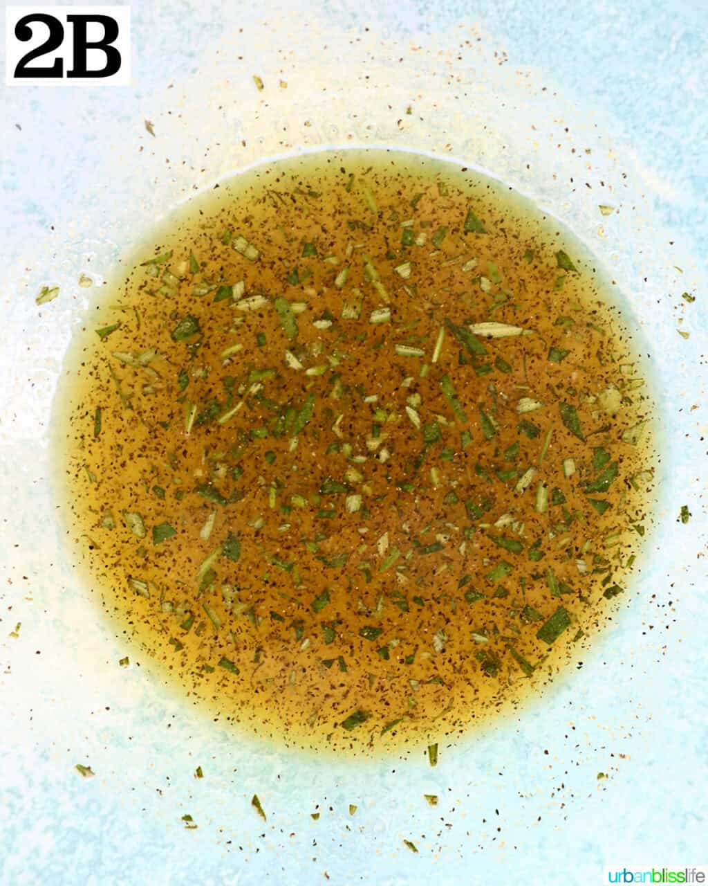 olive oil herb mixture in a glass bowl.