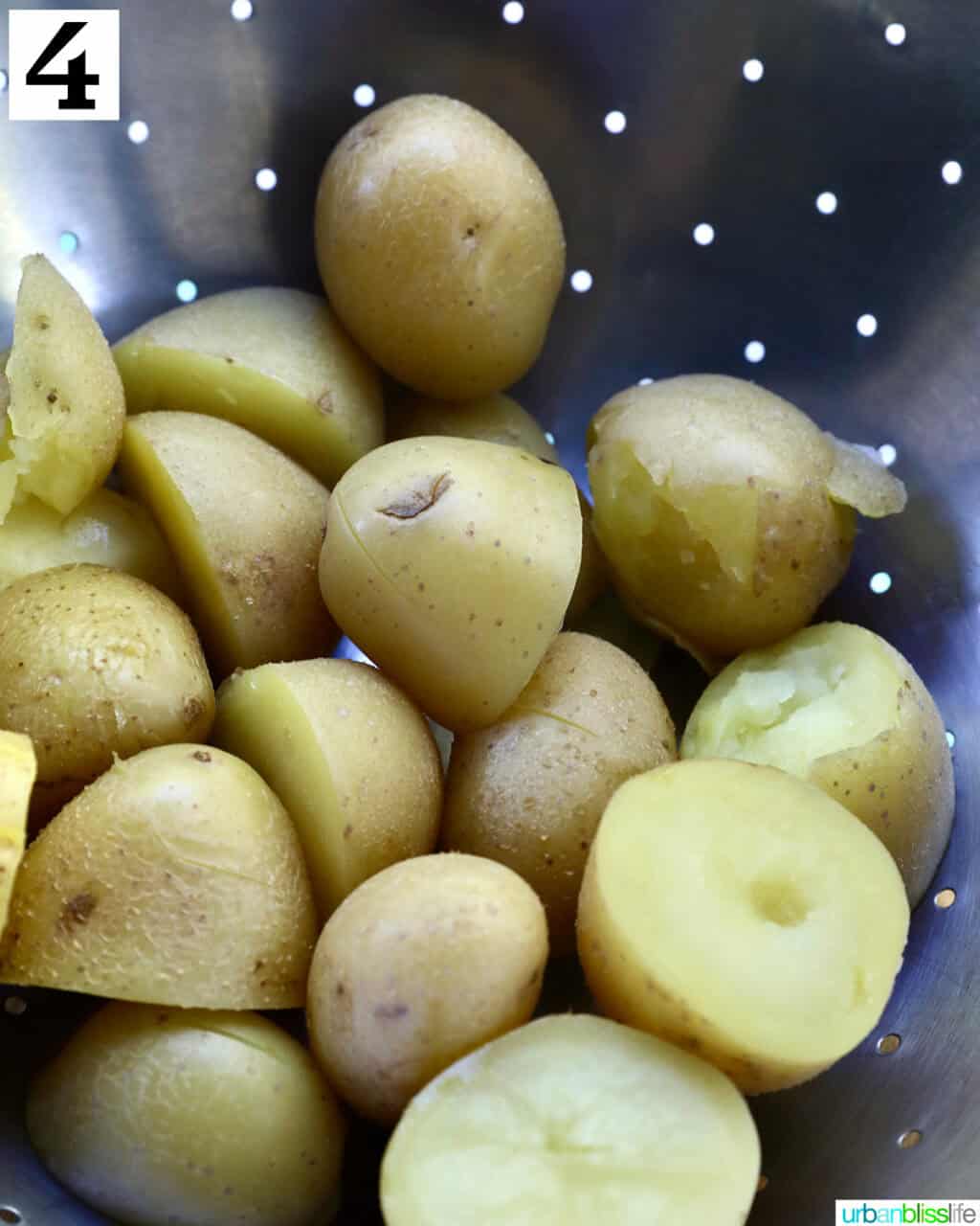 cooked baby potatoes in a strainer.