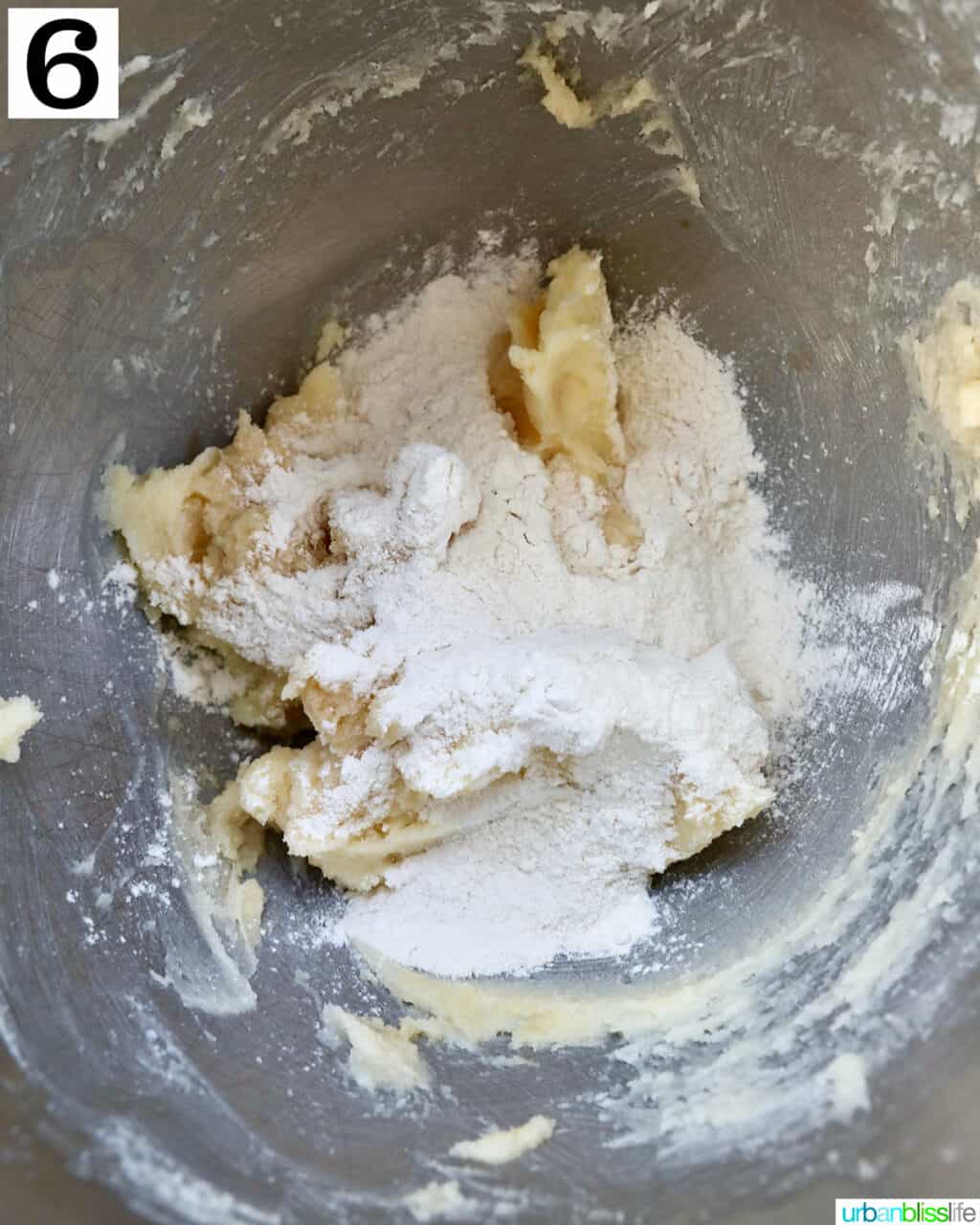 flour added to dough in a stand mixer bowl.