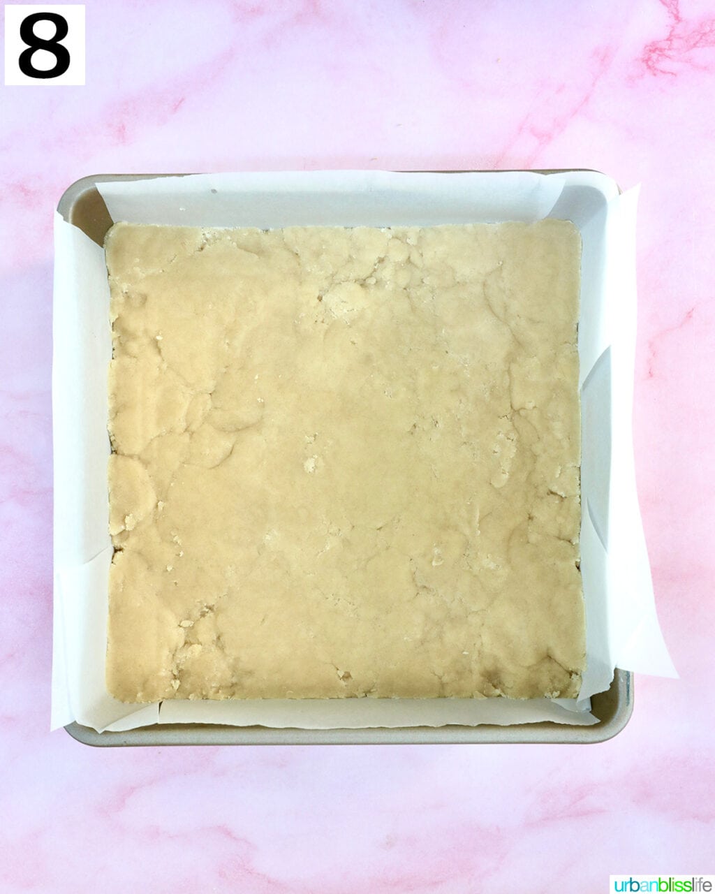 shortbread crust dough pressed into the bottom of a baking dish.
