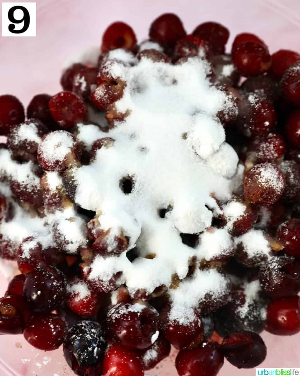 cornstarch and sugar on top of cherries in a bowl.
