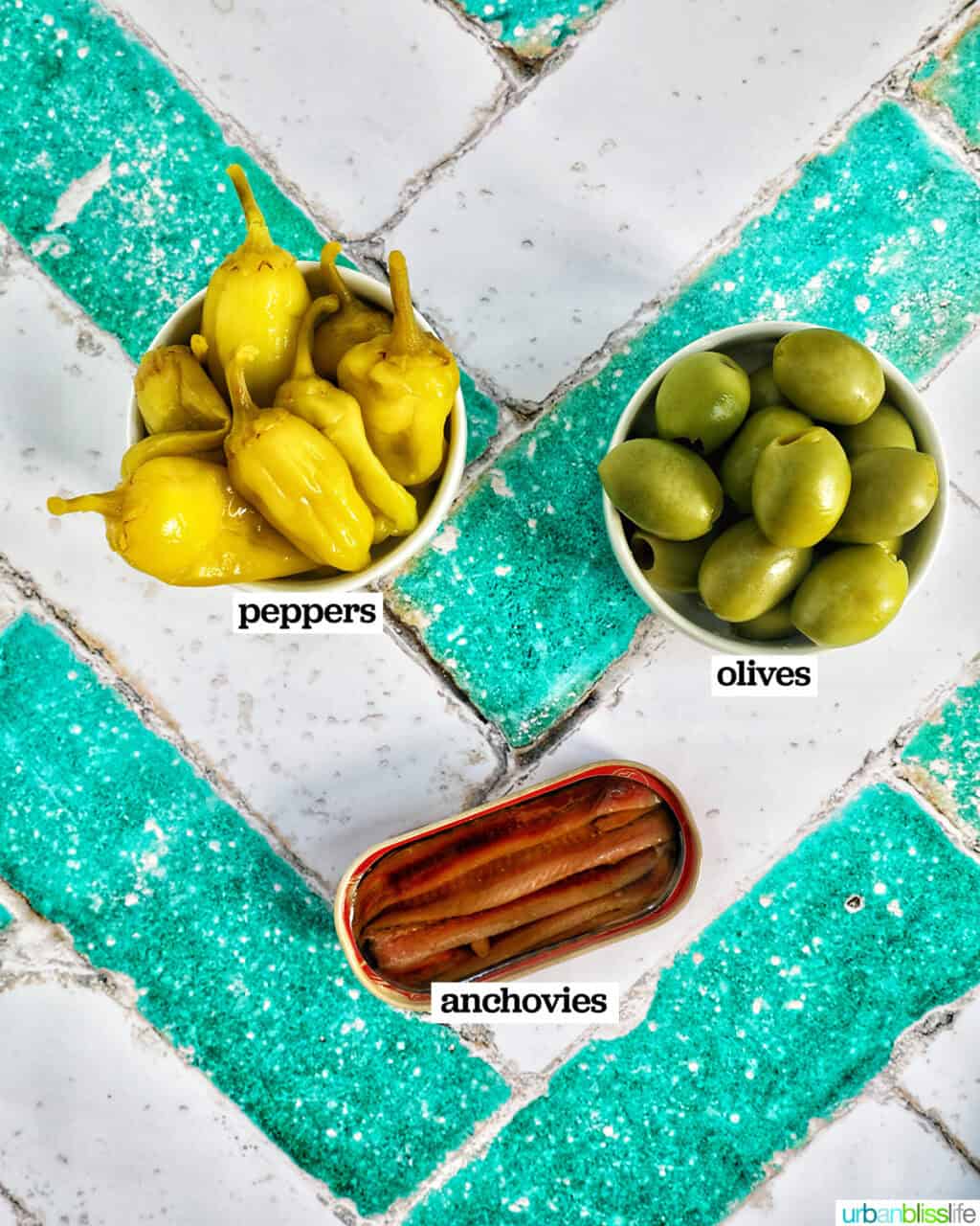 bowls of pepperoncinis and olives and tinned anchovies.