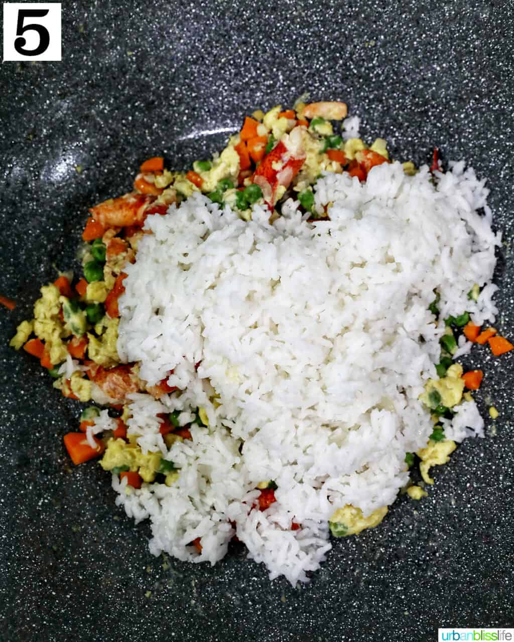 wok with lobster fried rice ingredients in it.