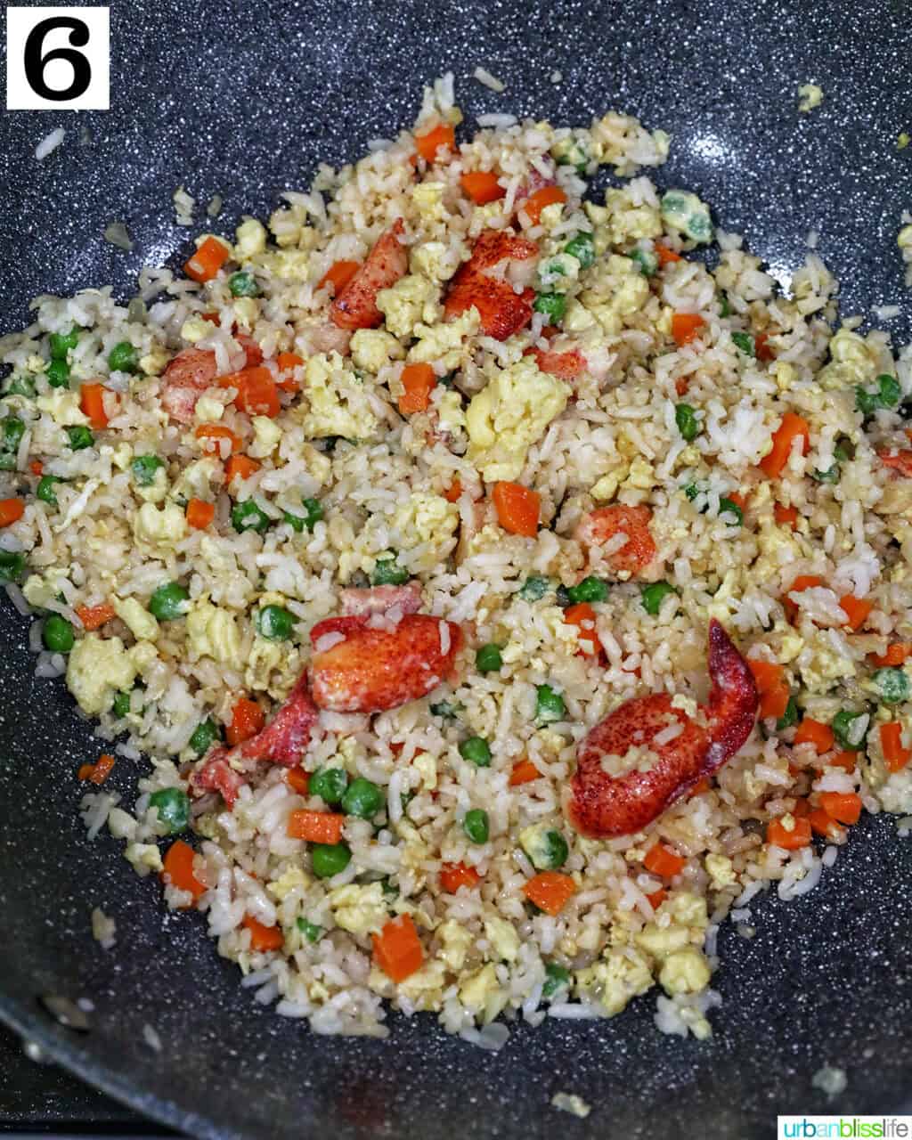 wok with lobster fried rice in it.
