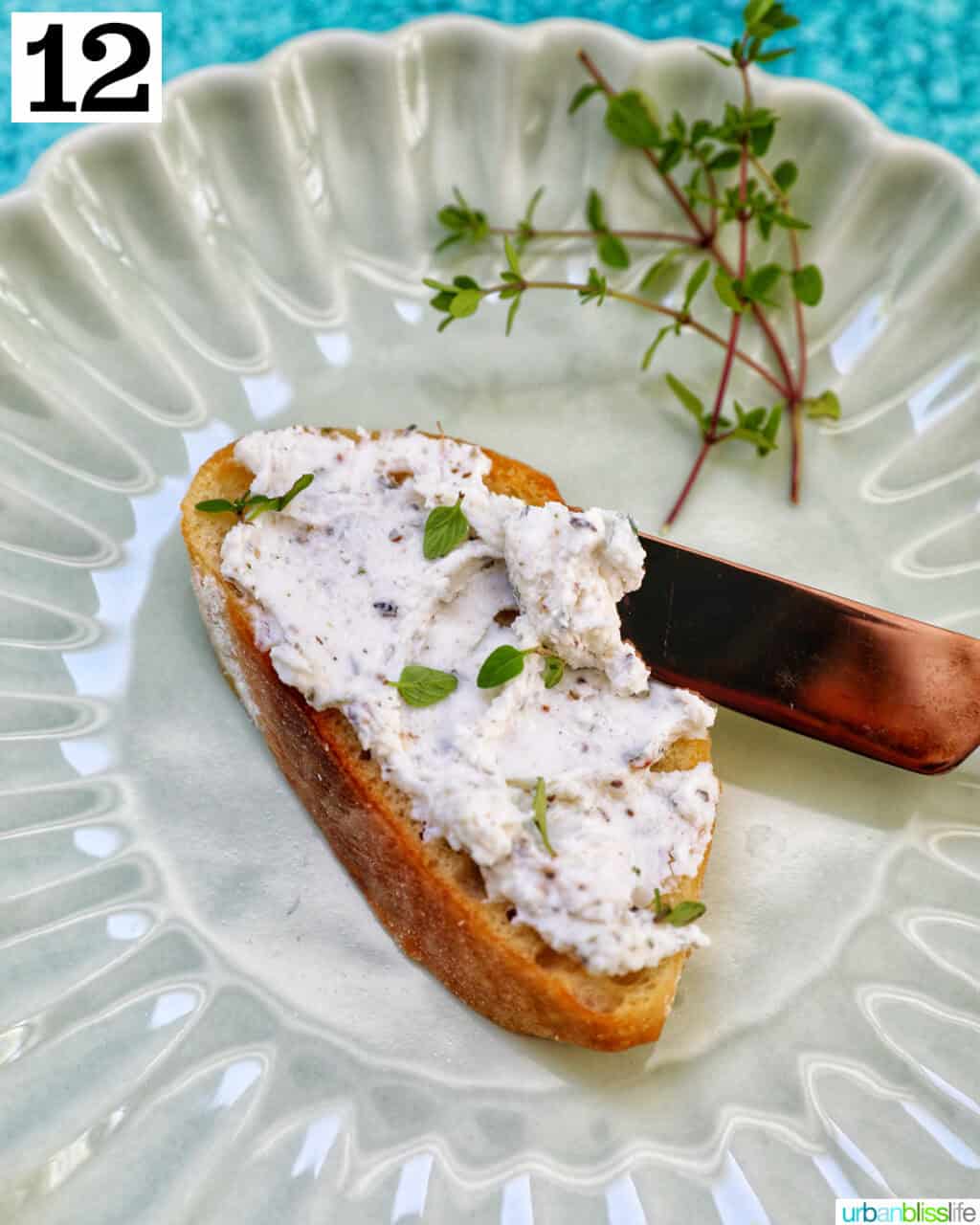 herbed goat cheese on toast with knife.
