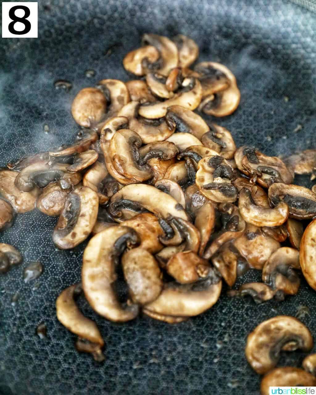 cooking sliced mushrooms in a cast iron skillet.