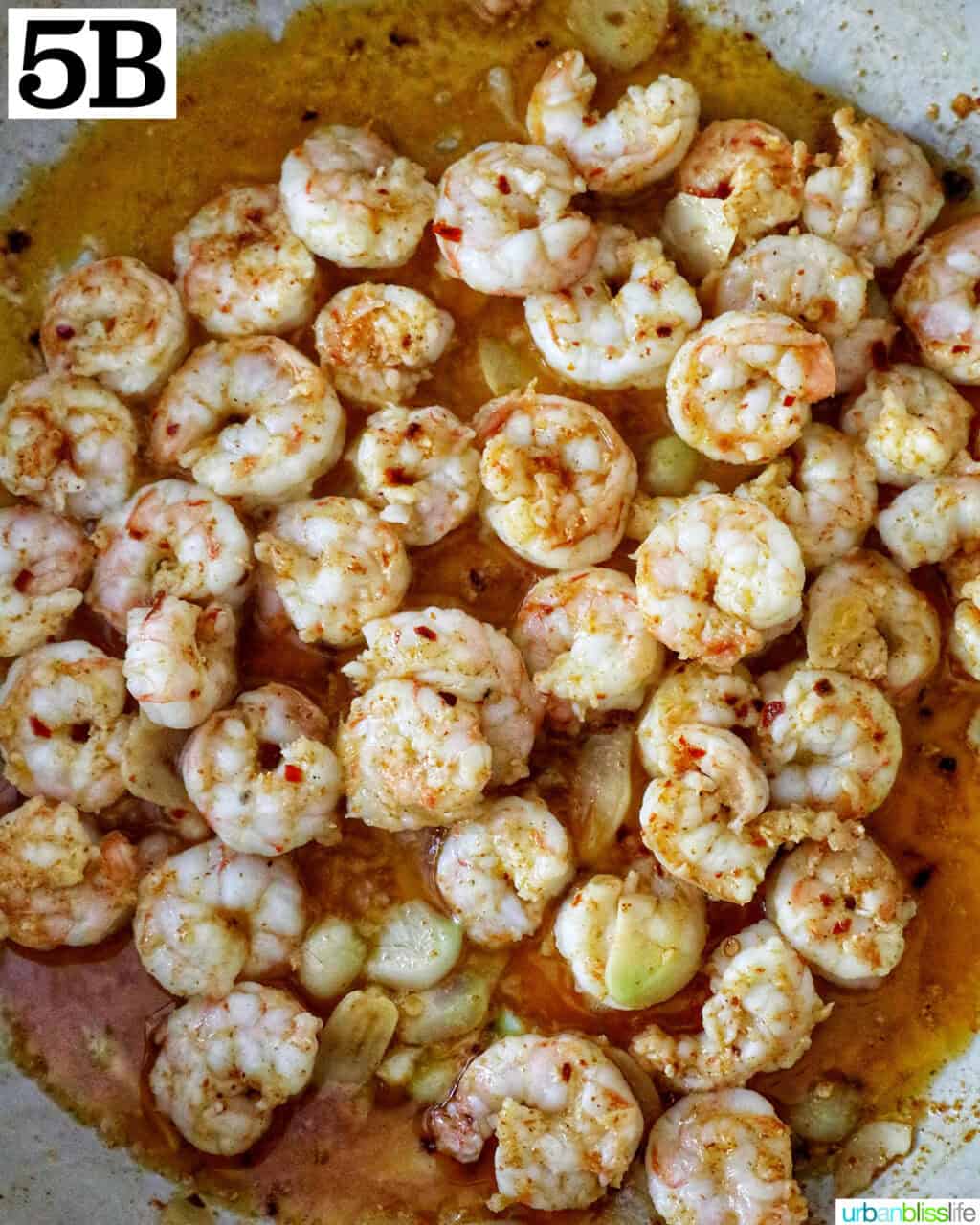 gambas al ajillo in a white pan.
