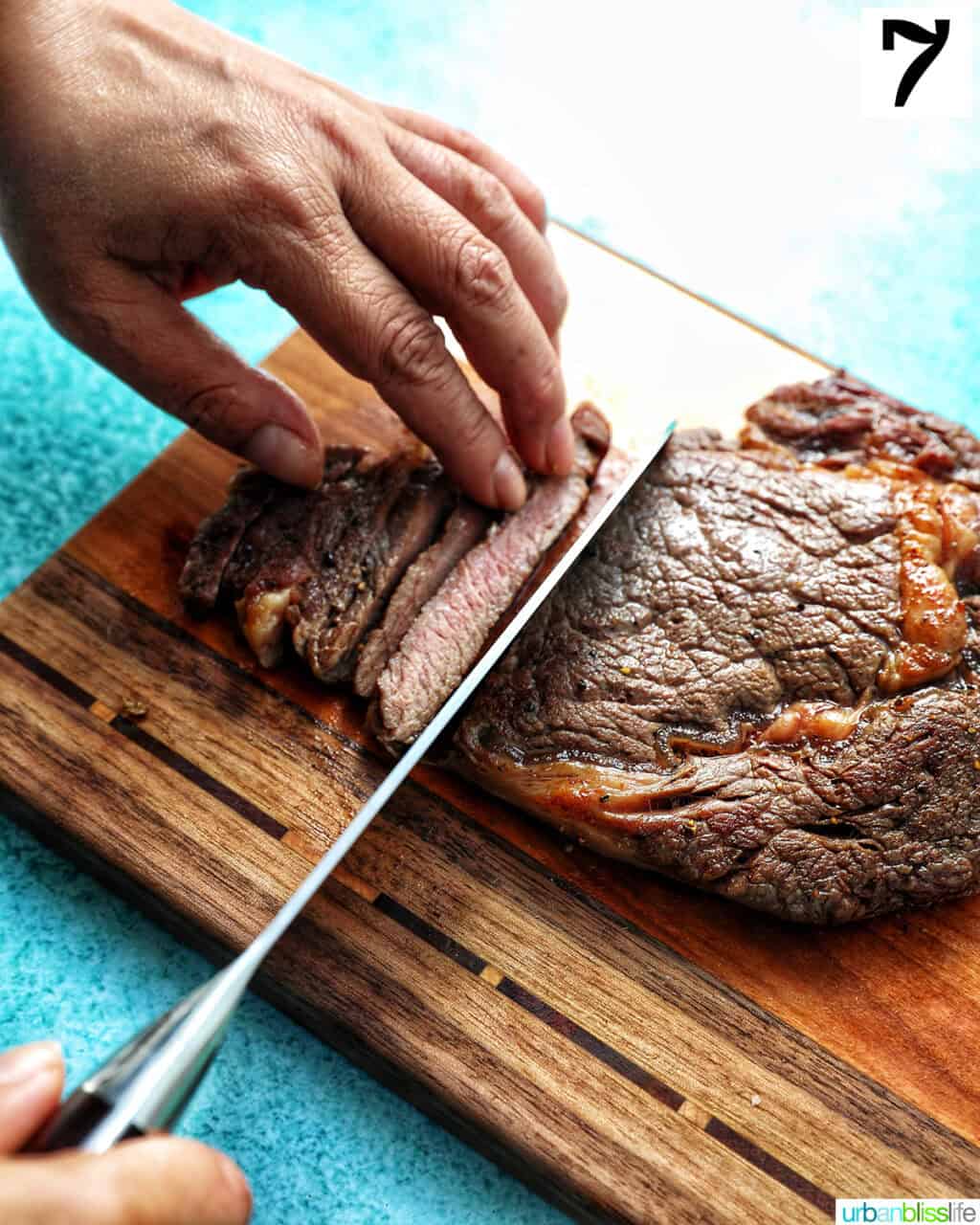 slicing steak on a cutting board.