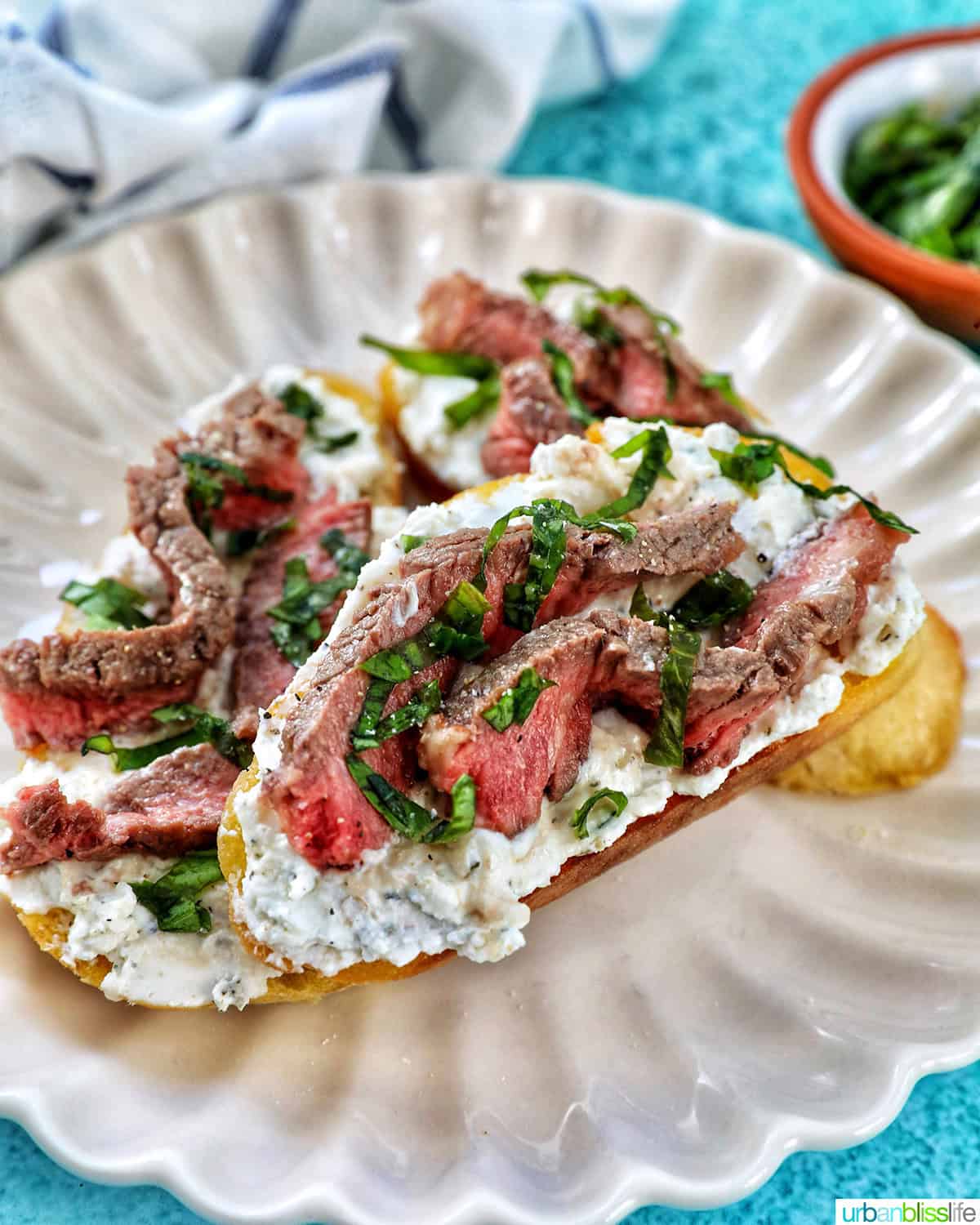 steak crostini on a plate.