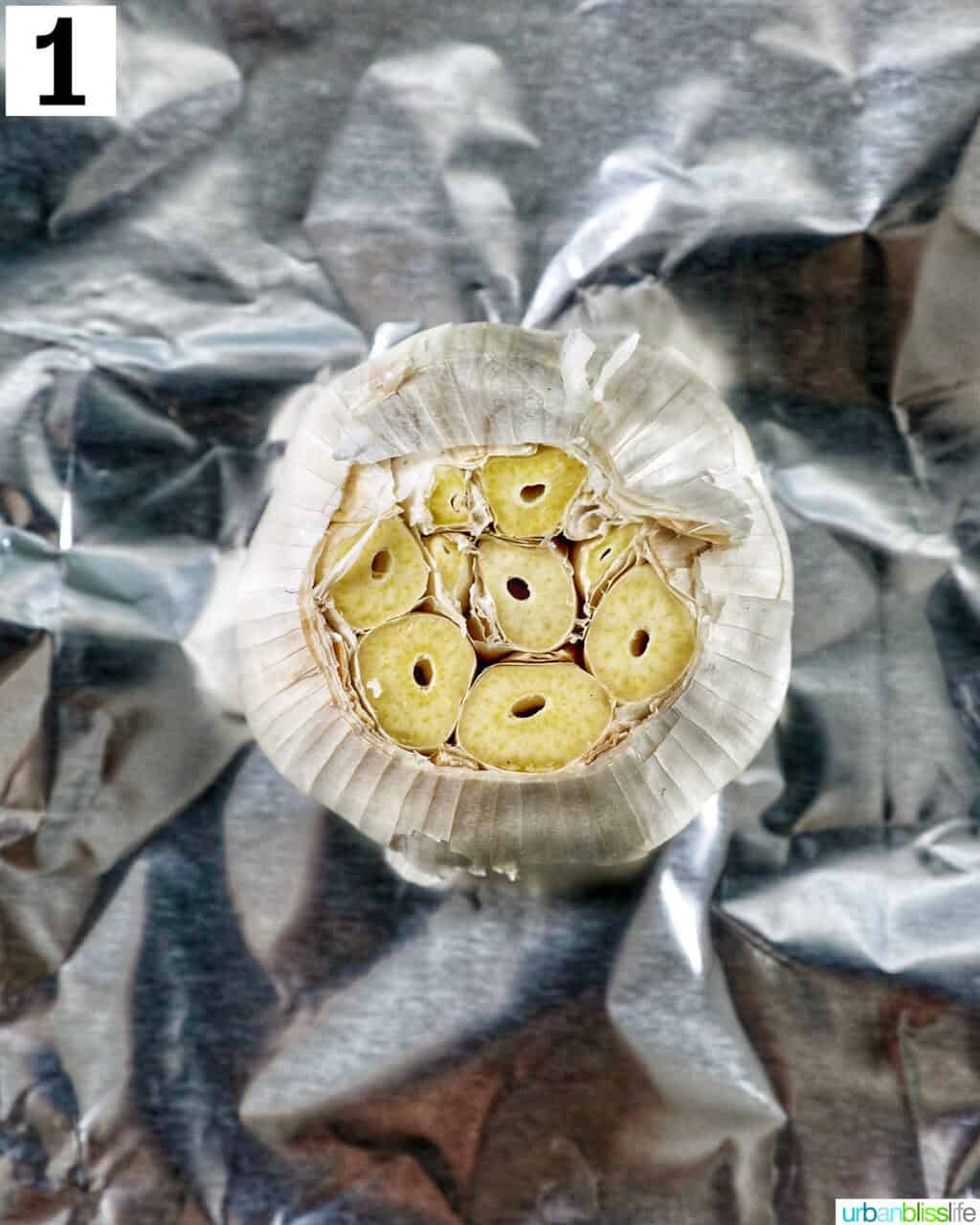 garlic head on aluminum foil.