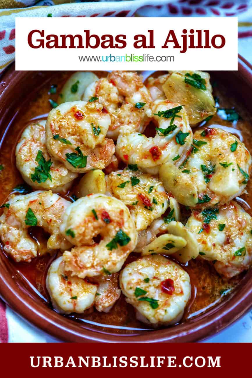 Spanish prawns with garlic in a traditional Spanish plate with title text that reads "Gambas al Ajillo."