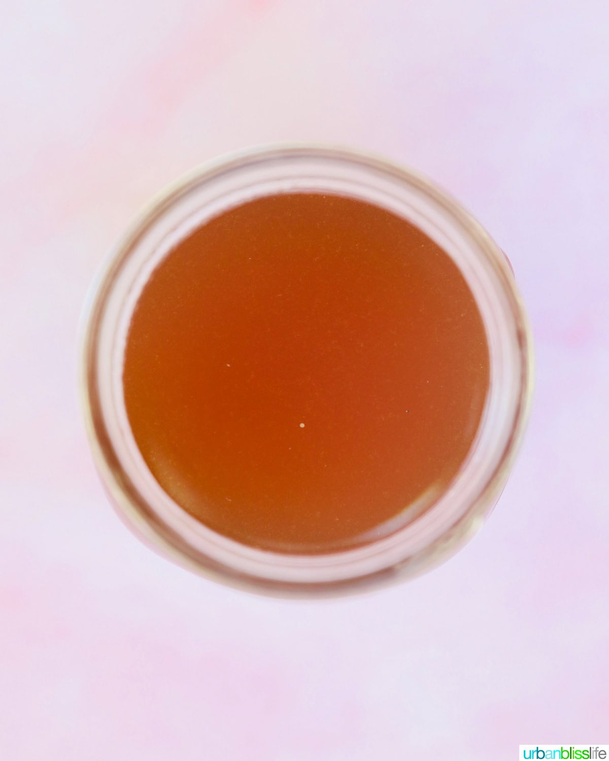 overhead of seafood stock in a mason jar.