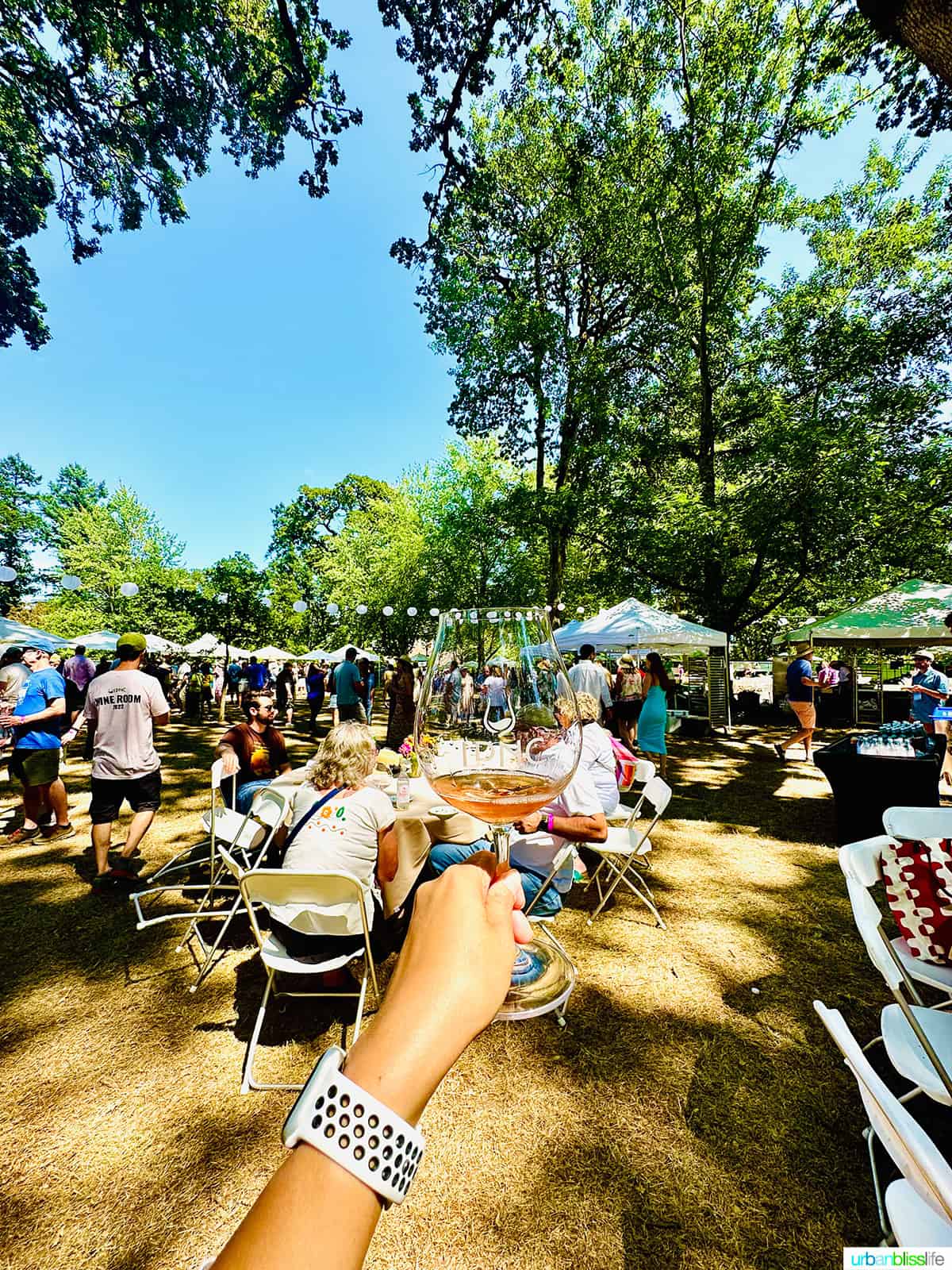 hand holding up a glass of rosรฉ of pinot noir at passport to pinot at IPNC.