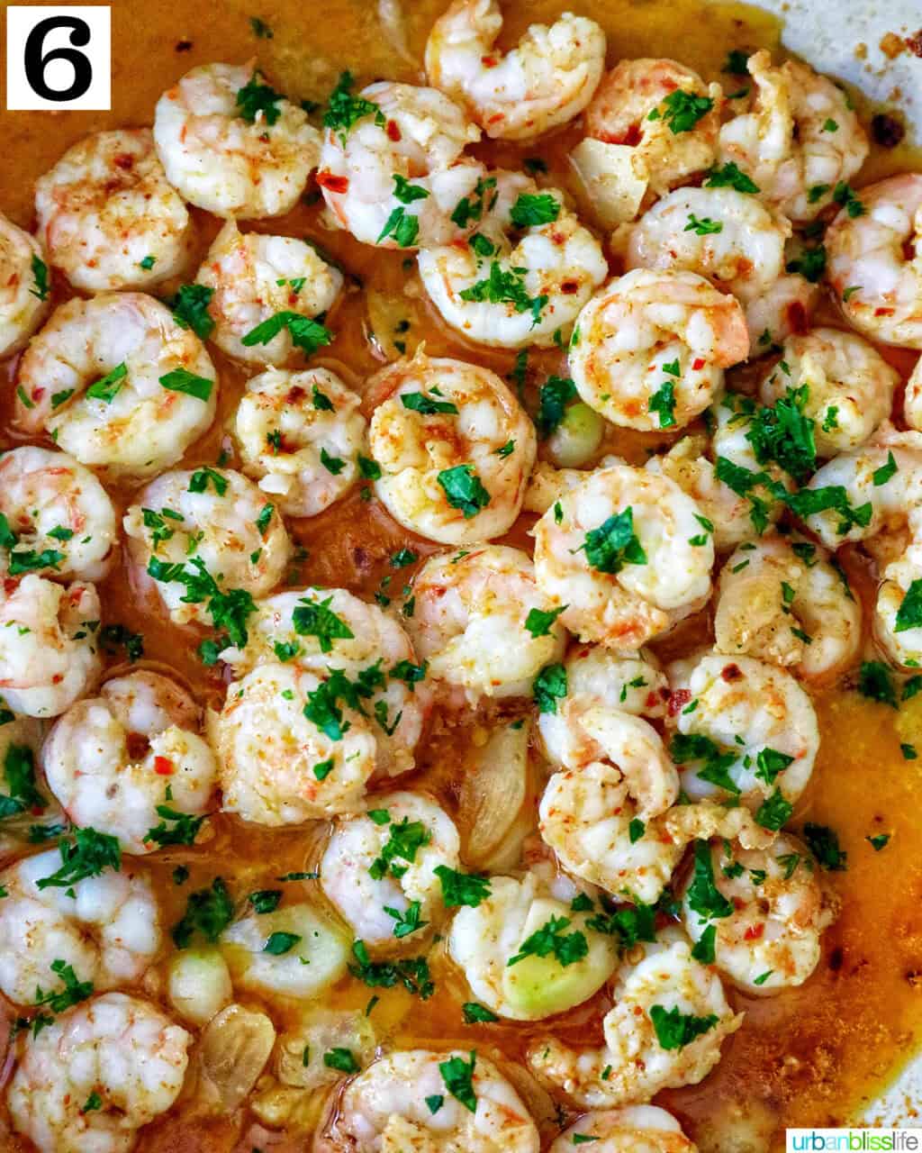 spanish prawns with garlic cooked in a skillet.